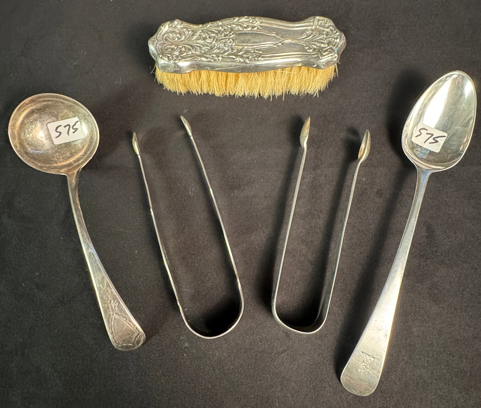 English Sterling Tongs, Serving Spoon and Ladle: A group of English hallmarked sterling silver to include a serving spoon (weighing 59.71 grams) with an etched dog on handle, a small ladle (weighing 51.49 grams) and 2 pairs of pickle/olive tongs (we