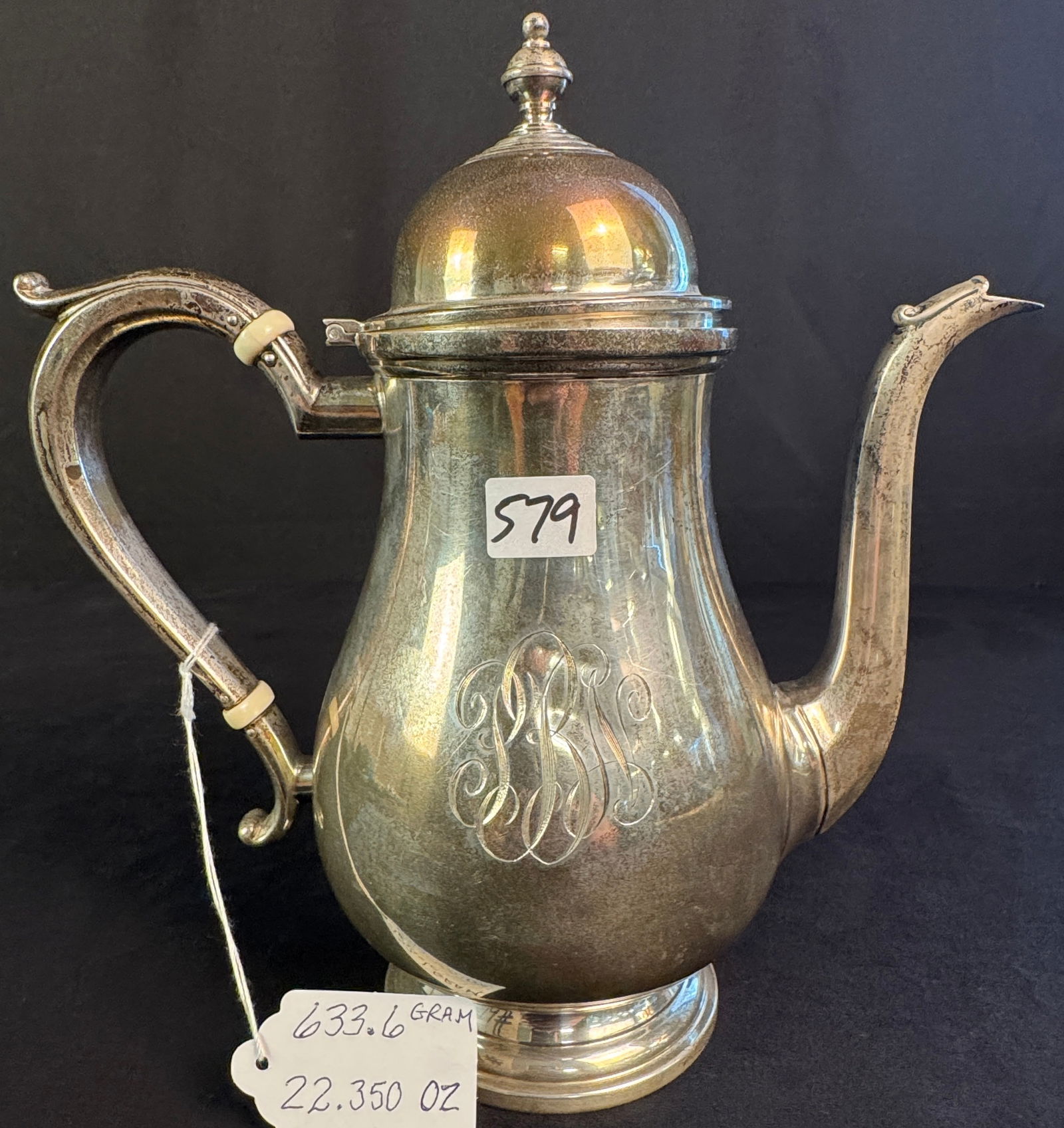 Sterling Colonial Style Coffee Pot: A sterling colonial style coffee pot with monogram. It weighs 633.6 grams or 22.350 ounces and scraps out to roughly $867.34.