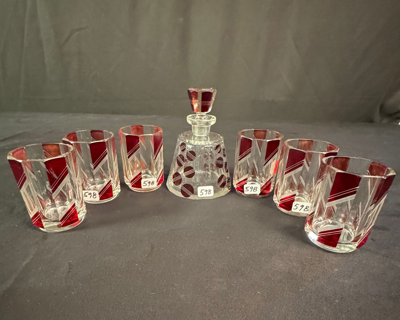 Cubist Deco Czech Cut Crystal Glasses, Perfume bottle c.1920's: A group of Art Deco/Cubist Czech cut crystal to include 6 ruby and clear geometric cut liquor glasses with ground edges and bottoms in excellent condition that measure 3" tall X 2" across, and a cut r