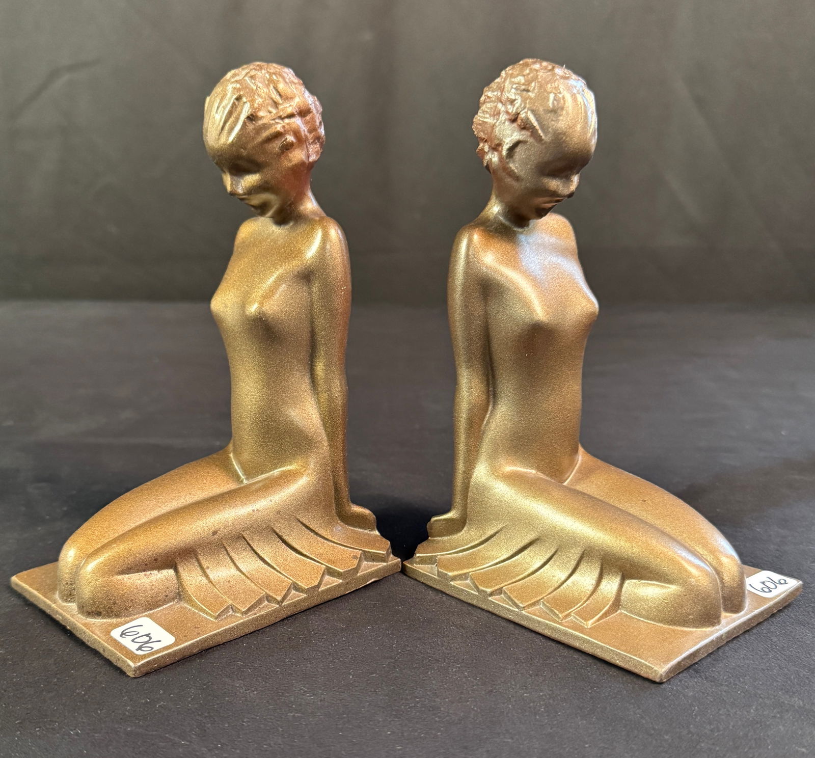 Quoizel Art Deco Nude Bookends C1920's: This pair of Quoizel signed pot metal Art Deco kneeling nude women bookends c1920's are in excellent condition. They each measure 7" tall X 3.5" across X 4.5" deep.