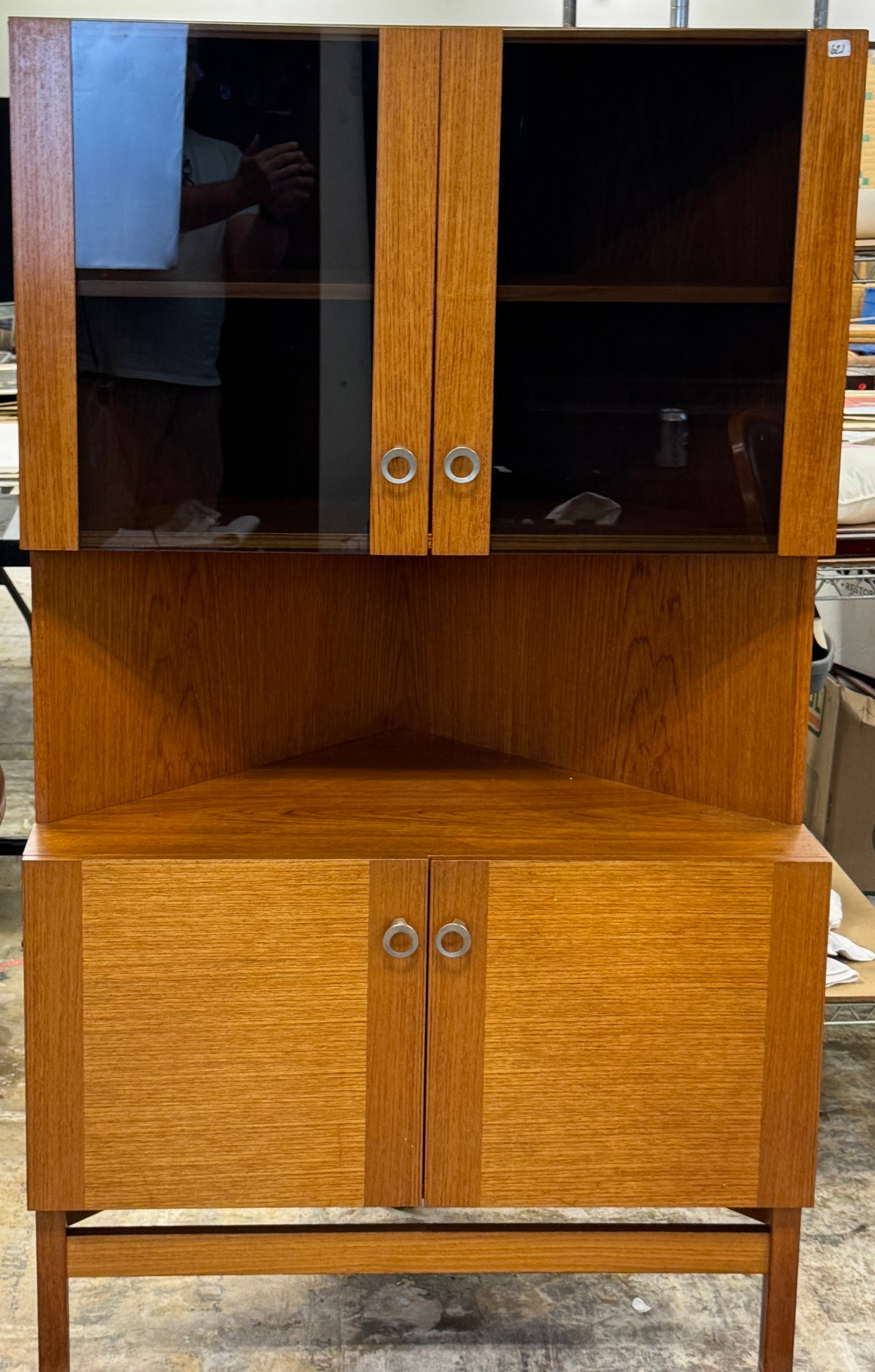 Danish P, Rimmes Teak Corner Cabinet c.1960's: A Danish Teak Mid Century Modern corner cabinet with smoked glass upper doors and round pulls by P. Rimmes Mobelfabrik (furniture makers) c.1960's in excellent condition. It measures 61.5" tall X 31.5