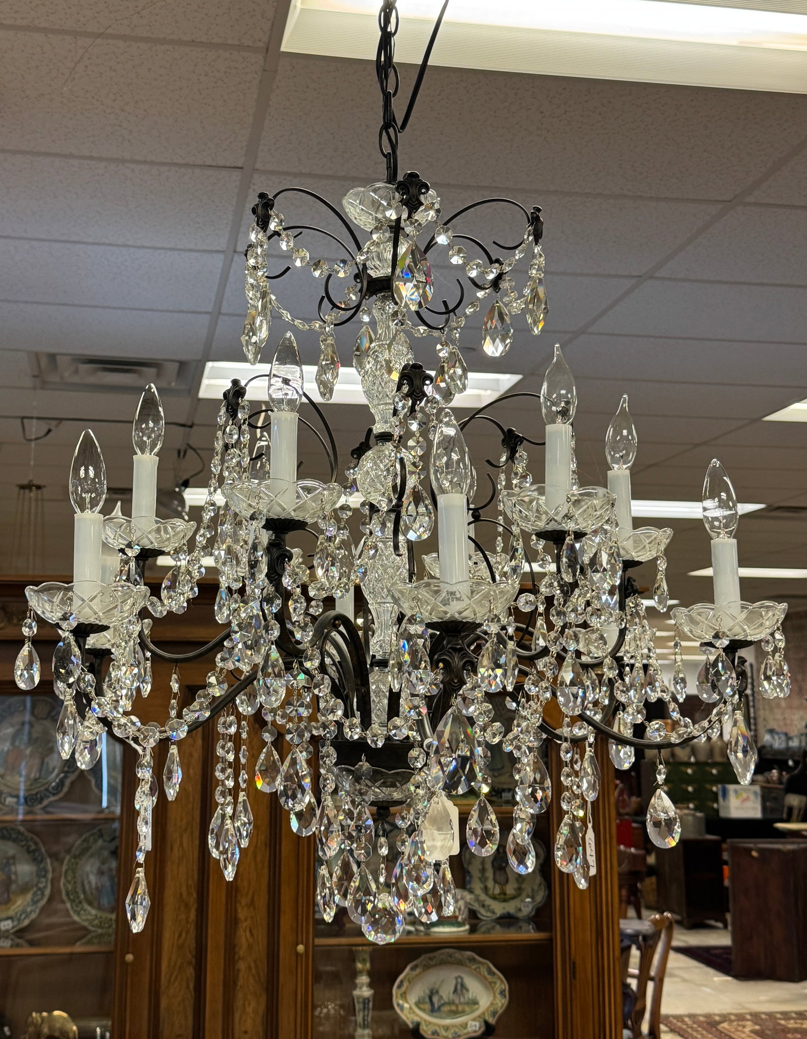 Contemporary 12 Arm Crystal Chandelier: A contemporary metal crystal 12 armed chandelier with strings and drops of cut crystal in excellent condition. It measures