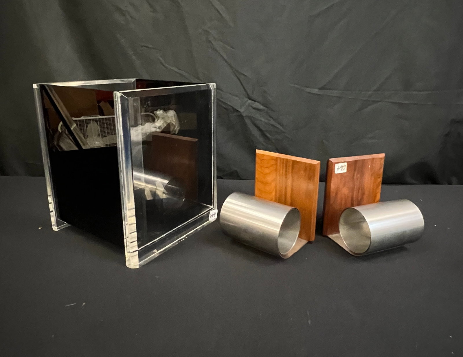 Lucite Waste Basket, Walnut Bookends: A vintage black and clear Lucite waste basket (10" tall X 8" X 8" ) c.1970's in good condition, and a pair of walnut and steel curved bookends in excellent condition.