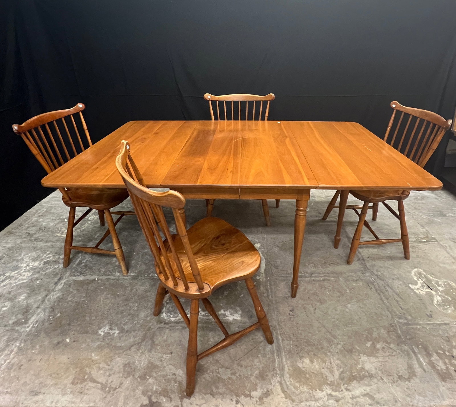 Leopold Stickley Cherry Drop Leaf Table and 4 Matching Windsor Chairs c1955: A Leopold Stickley cherry dining set c1955 to include a drop leaf table, and 4 matching Windsor chairs in good condition. Table measures 30" tall X 27" with the leaves down, and 73" with them open. Ch