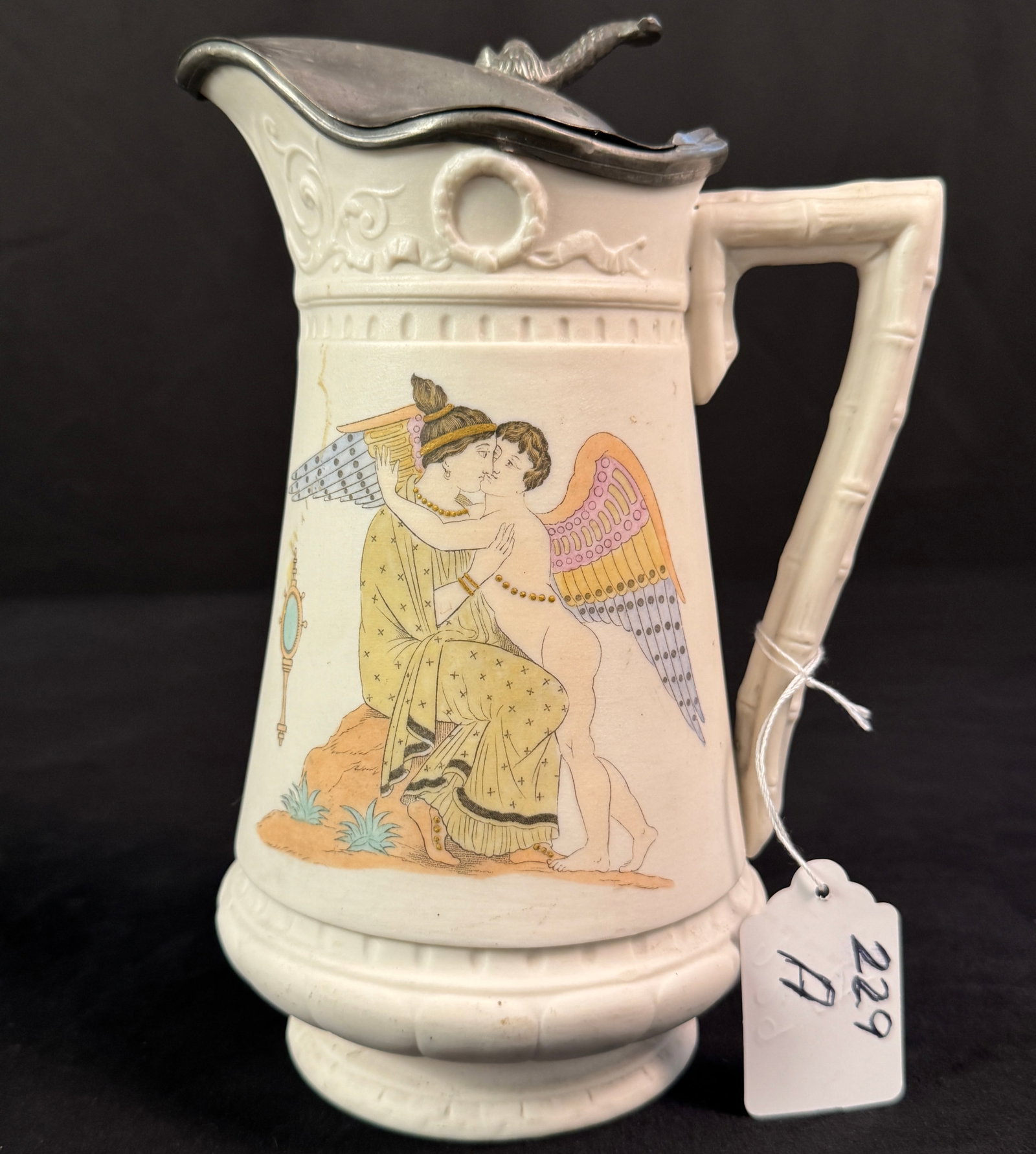 Hand-Painted Parian Pitcher: Hand-painted Parian pitcher depicting Greek goddess with cupids and fancy pewter top, measures 9"h x 7"w.