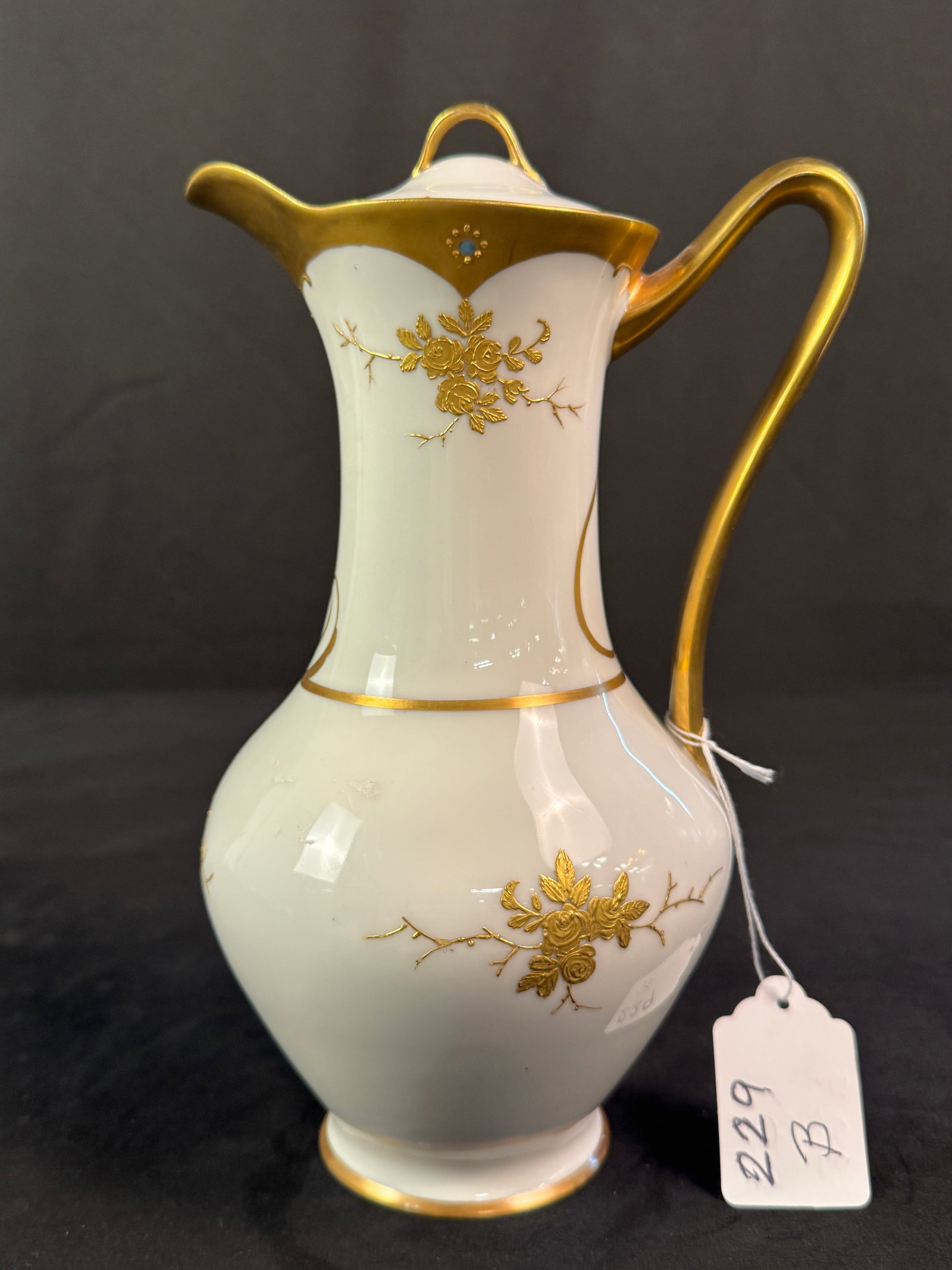 Limoges Chocolate Pot Pitcher: A Limoges chocolate pot or pitcher with cover, with raised gold decorations, in excellent condition. Measures 10"h x 6"w.