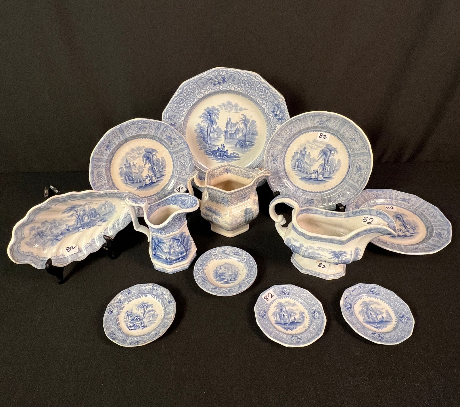 Mixed Group of Blue Transferware C1840's/50's: A mixed group of ironstone blue transferware to include 4 Addams butter pats, a J.C. Fairchild relish dish, 3 (8") Addams dessert plates in the "Columbia" pattern, 2 creamers, and a gravy boat.