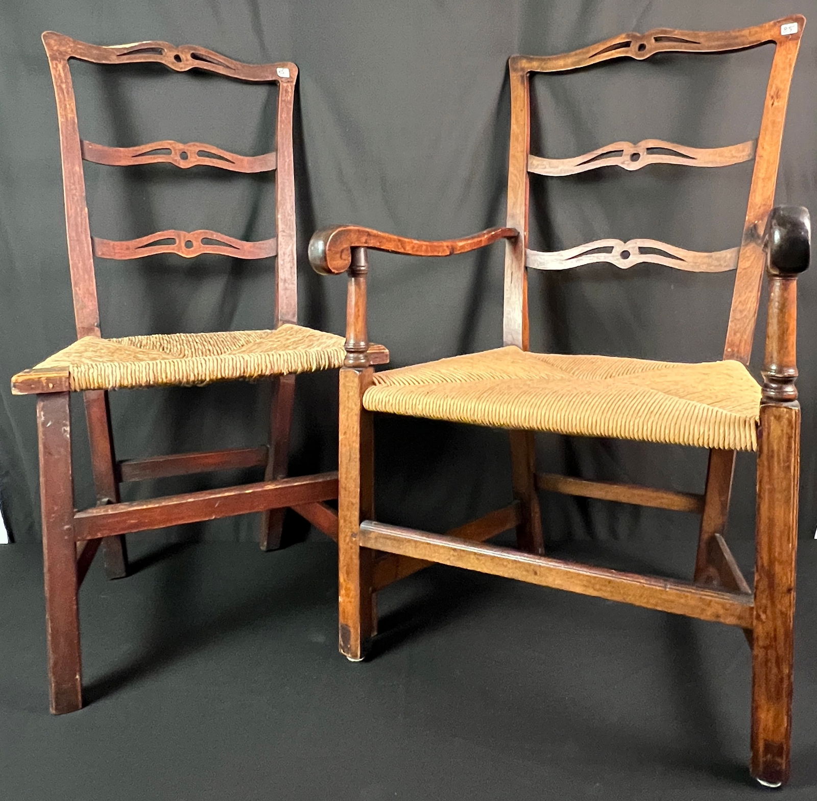 Chippendale Ribbon Back Rush Set Armchair and Side Chair c: A pair of Chippendale country ribbon back rush seat chairs c 1800 to include a mahogany rush seat armchair with original surface and replaced seat that measures 38" tall X 23" across X 21" deep that