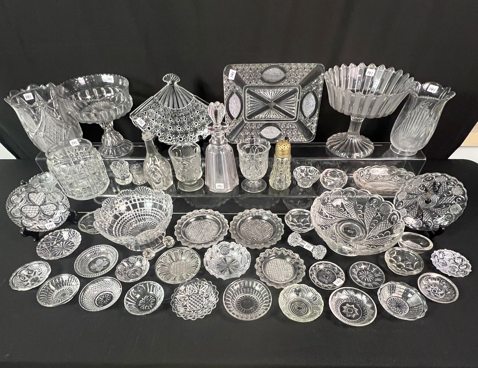 Mixed Group of Early Flint Glass: A mixed group of early Flint glass c1850-1900 to include a "Frosted Ribbon" footed compote, Hawaii pattern decanter, Pennsylvania pattern celery vase, Zipper and Moon celery vase, spooners, butter