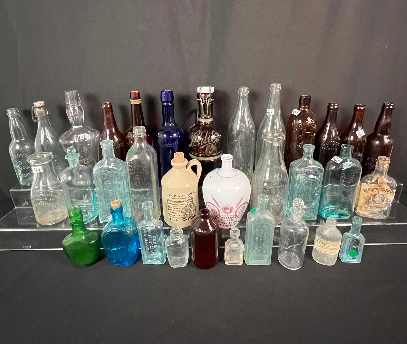 Group of Early Milwaukee Bottles, Schlitz, More!: A huge group of early Milwaukee bottles to include Schlitz, Pabst, a cobalt bourbon bottle, Pennsylvania Club whiskey bottle, Manhattan Bottling Works bottle, Lydia E. Vegetable Compound bottle, Peych