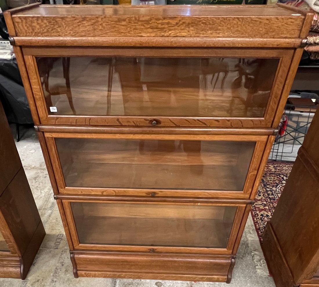 3 Section Oak Stacking Bookcase: An oak 3 section stacking bookcase in original finish. It retains its original base and top. It measures 47" tall X 34" across X 11.5" deep.