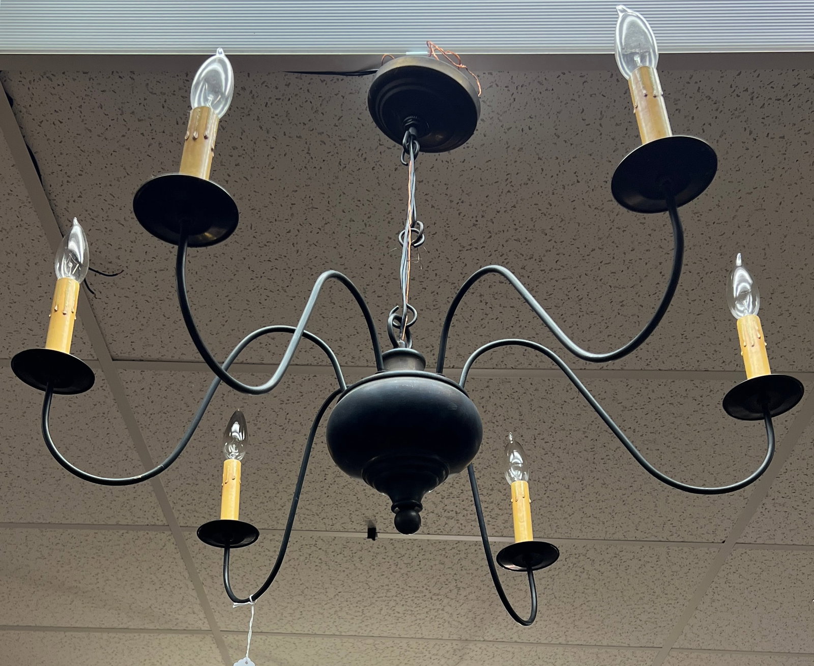 Black Metal Chandelier: A black metal 6 arm light fixture in a traditional style. It is in fair, as found condition. It measures 9" tall X 29" across.