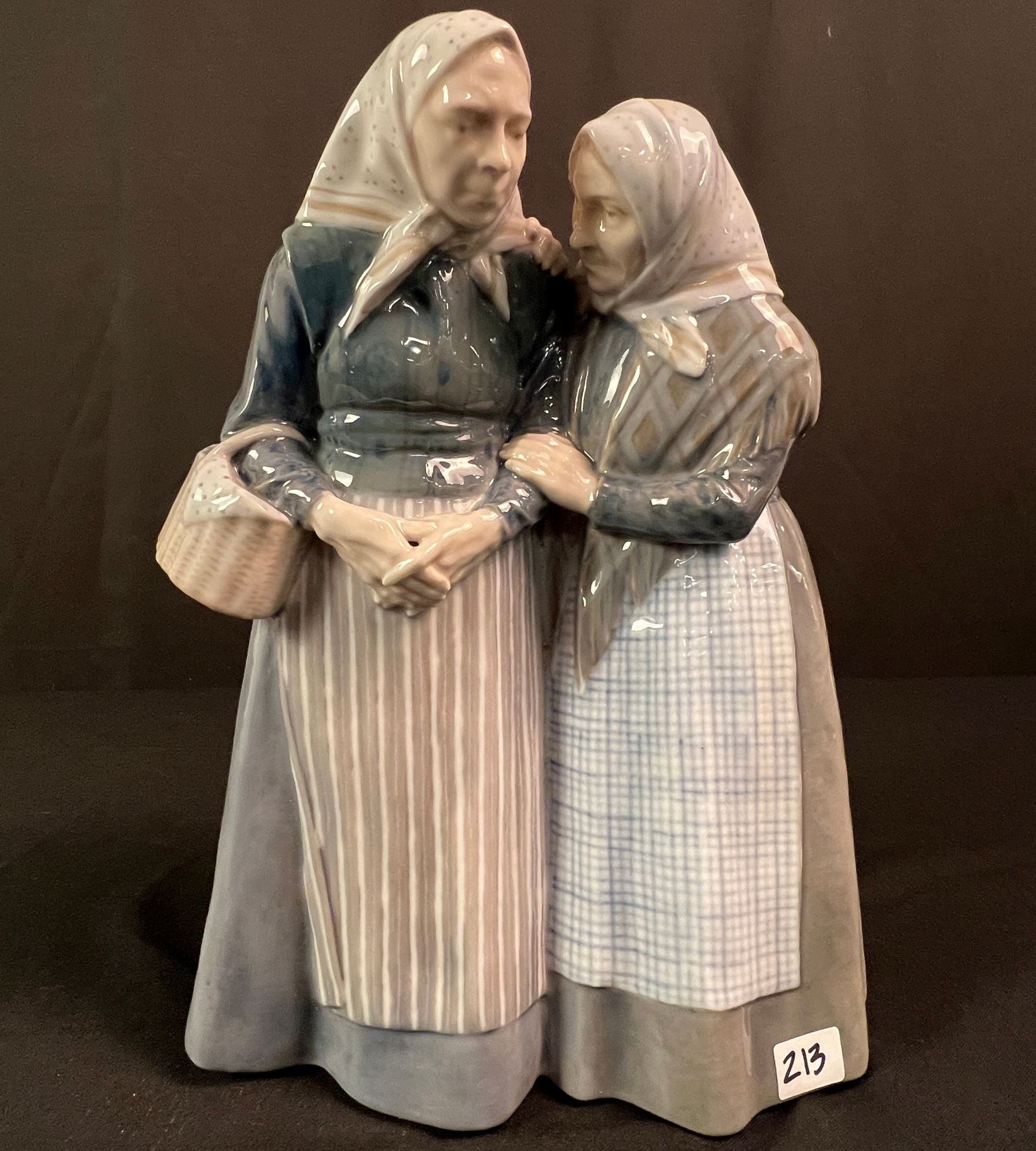 Royal Copenhagen Large Porcelain Figure "The Gossips": A Large Royal Copenhagen Porcelain figurine titled "The Gossips" that features two older women raking somebody over the coals in excellent condition.