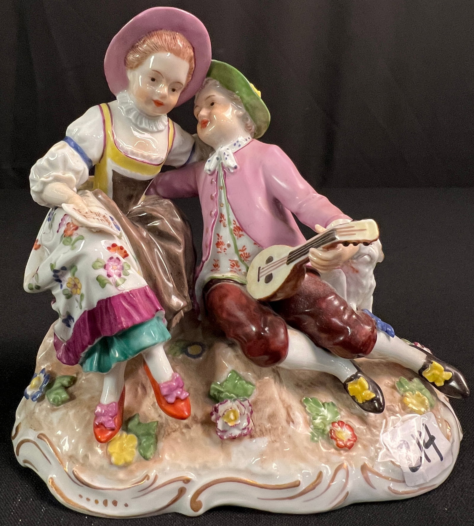 Royal Vienna Porcelain Figurine C19th Century: A Royal Vienna porcelain figurine C19th Century that features a young man with a lute going in for a kiss with a lady holding music and a little dog in excellent condition. It measures 6" tall X 7"