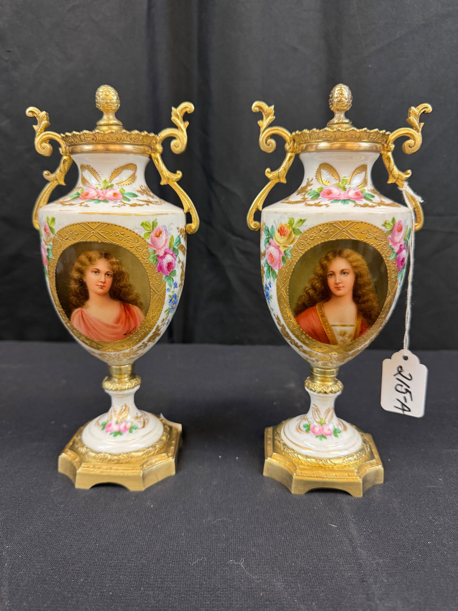 Pair of Sevres Urns: A pair of Sevres porcelain floral urns with portraits. They are signed on the base and on bronze mounts, measuring 9.5" tall.