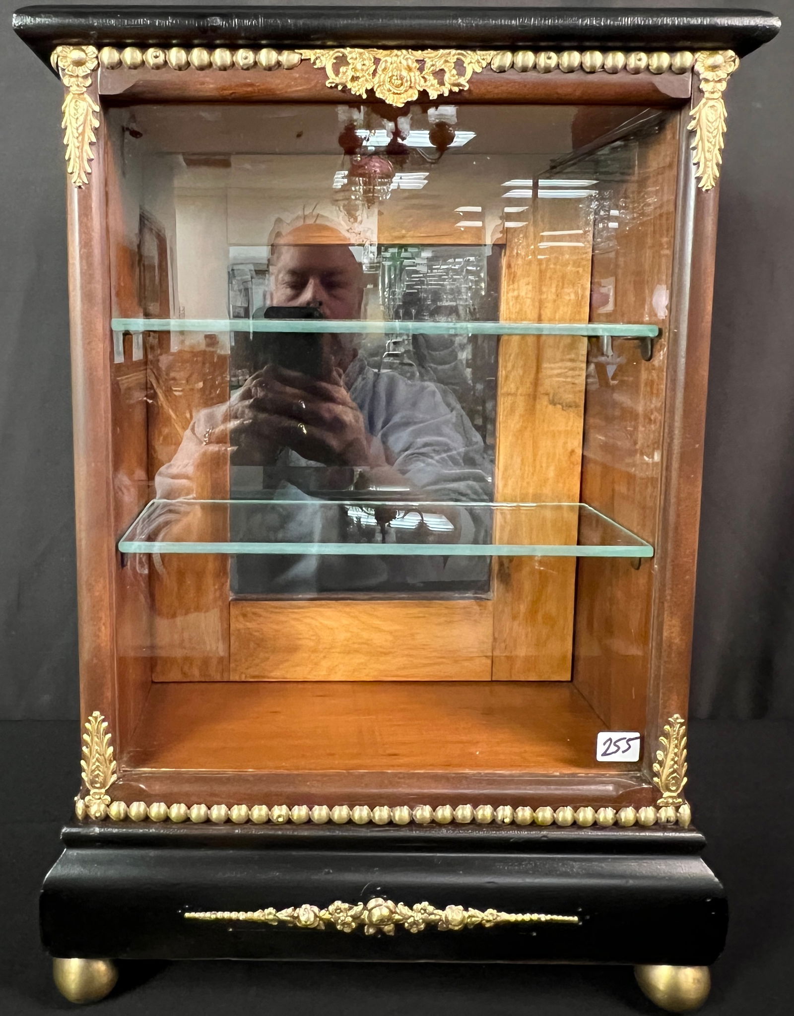 French Empire Display Case: A vintage mahogany and ebonized French Empire display case with ormolu trim, brass ball feet, with access through the back with a mirrored door. This wonderful second Empire measures 20" tall X 14"