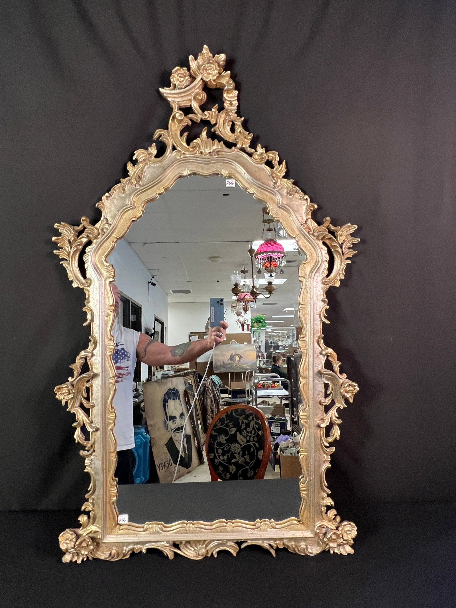 Hand Carved Rococo Style Gilded Wood Mirror: A hand carved Rococo style gilded wooden mirror in excellent condition. It measures 49" tall X 29" across.