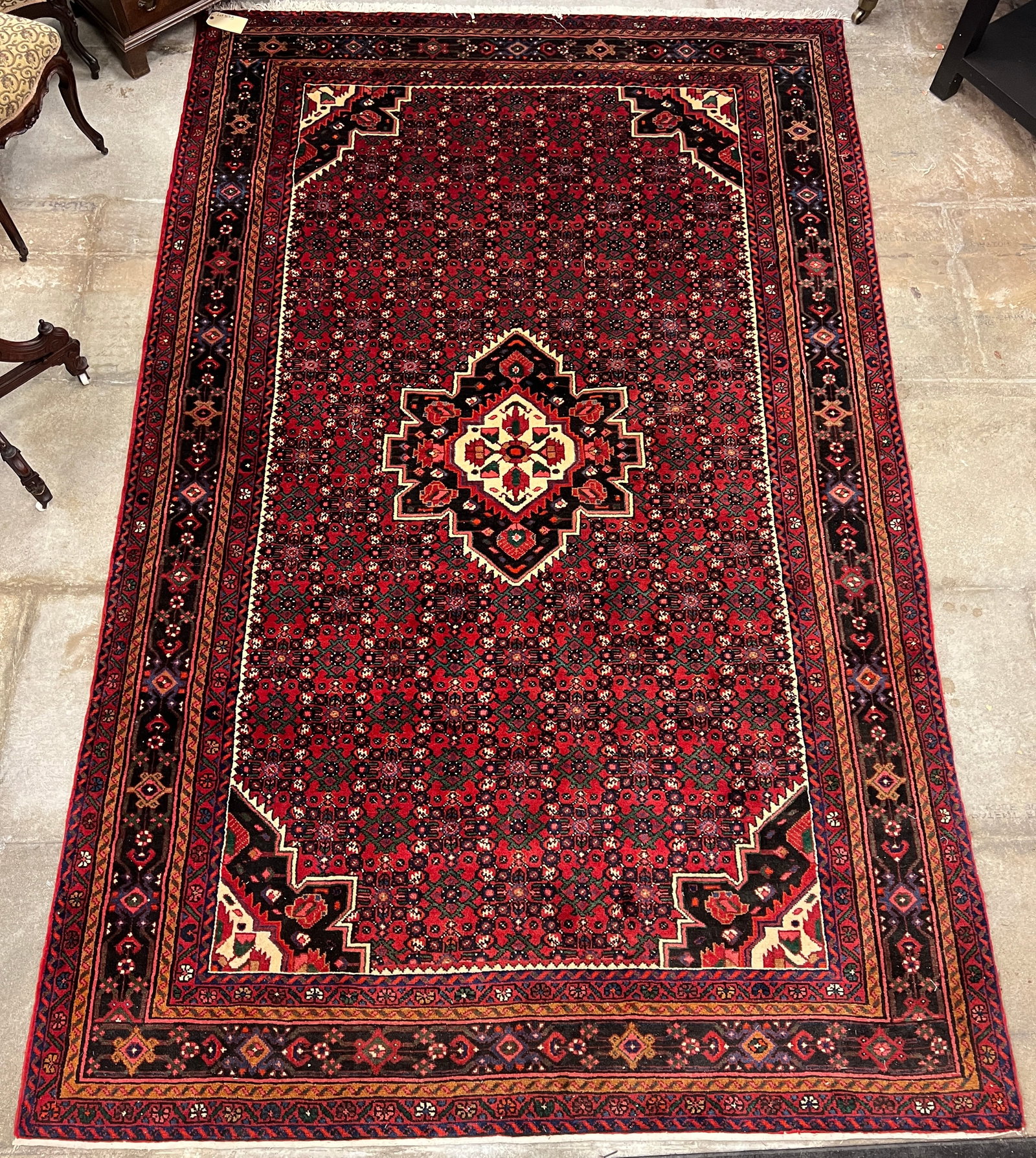 Hamadan Persian Hand Tied Rug: A Hamadan Persian hand tied rug with 7 borders and features and quality thick pile. Rug is done in vibrant reds, blues, greens, and cream in a geometric pattern. In excellent condition, this measures