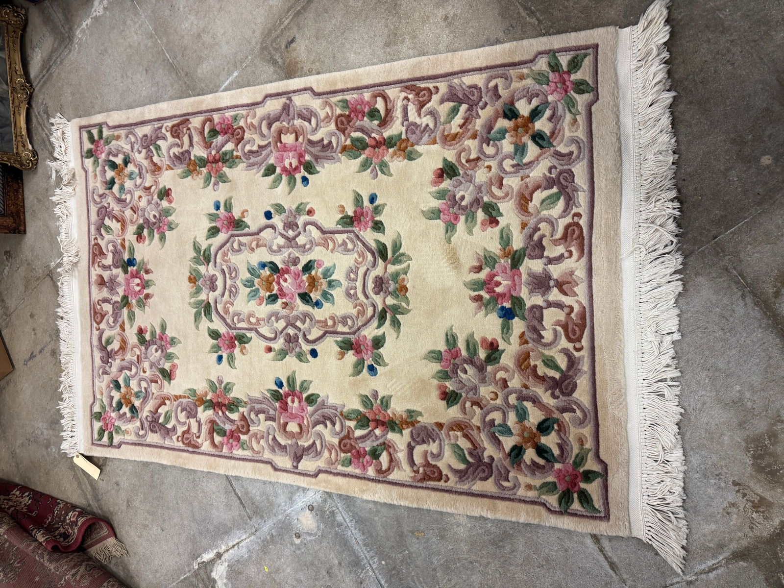 Oriental Sculpted Hand Made Wool Rug: An Oriental sculpted handmade wool rug that features floral designs in creams, pinks, blues, greens and browns. In excellent condition it measures 74" long X 48" across.