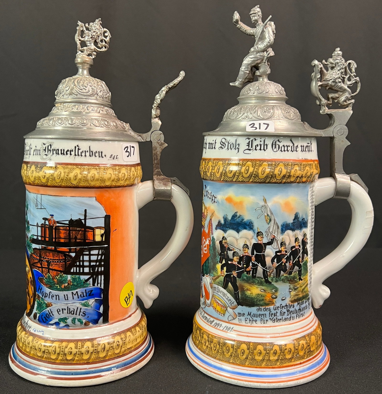 2 Regimental Lithophane Beer Steins, c1901: A pair German regimental beer steins. The first regimental beer stein c1901 features a hand painted scene of soldiers at battle and the name "Gefreiter Treser" who the mug was presented to for his mil