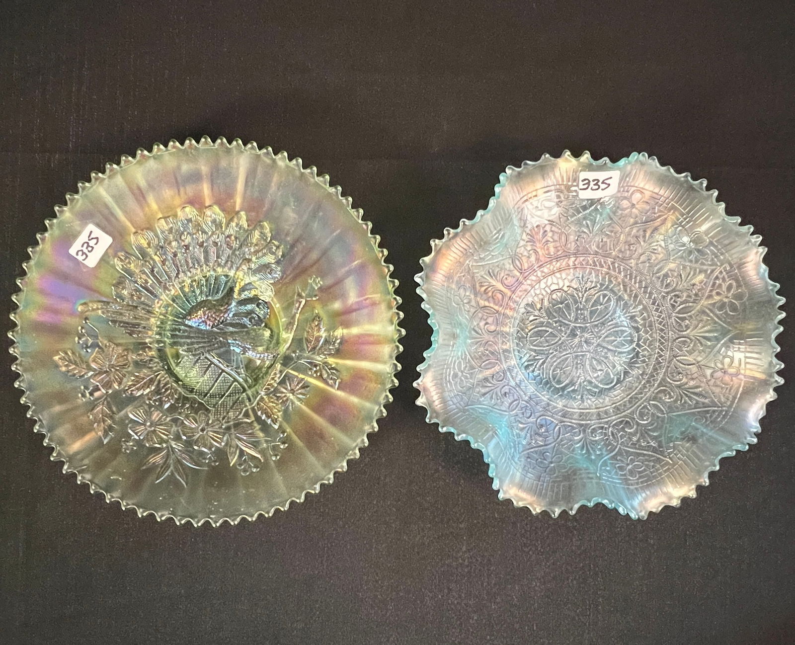 Rare Iceberg Blue and Green Carnival Bowls: A rare ice green carnival glass shallow bowl depicting a peacock, measuring 6.5" across. Along with an ice blue ruffled-edge carnival glass bowl with a hearts and flowers pattern, measuring 8" across.