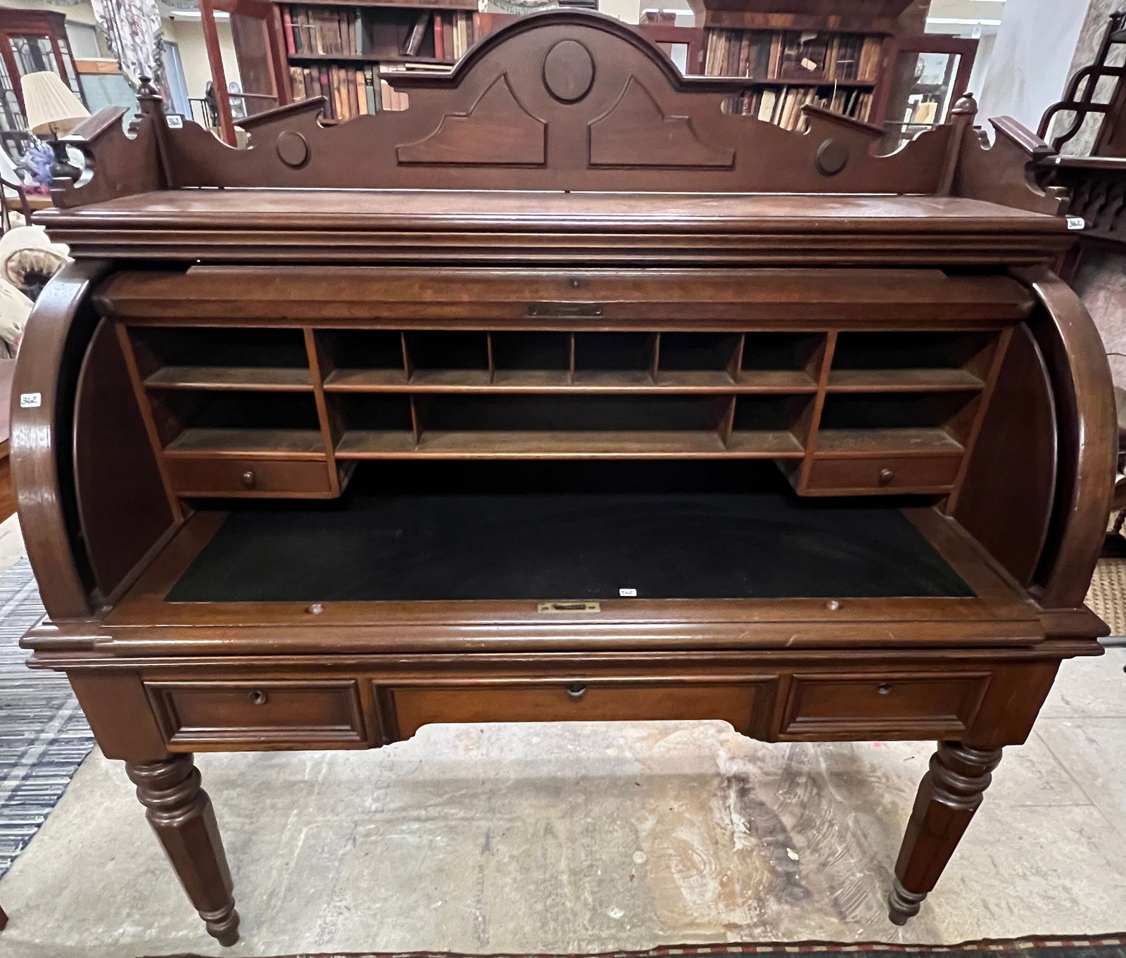 Oversized Victorian Barrel Front Rolltop 1840s/50s: A Renaissance Revival black walnut barrel front rolltop with chamfered panels, elaborate backsplash, pull out desk section, fitted interior, 3 drawers, and turned octagon legs. This rolltop is from