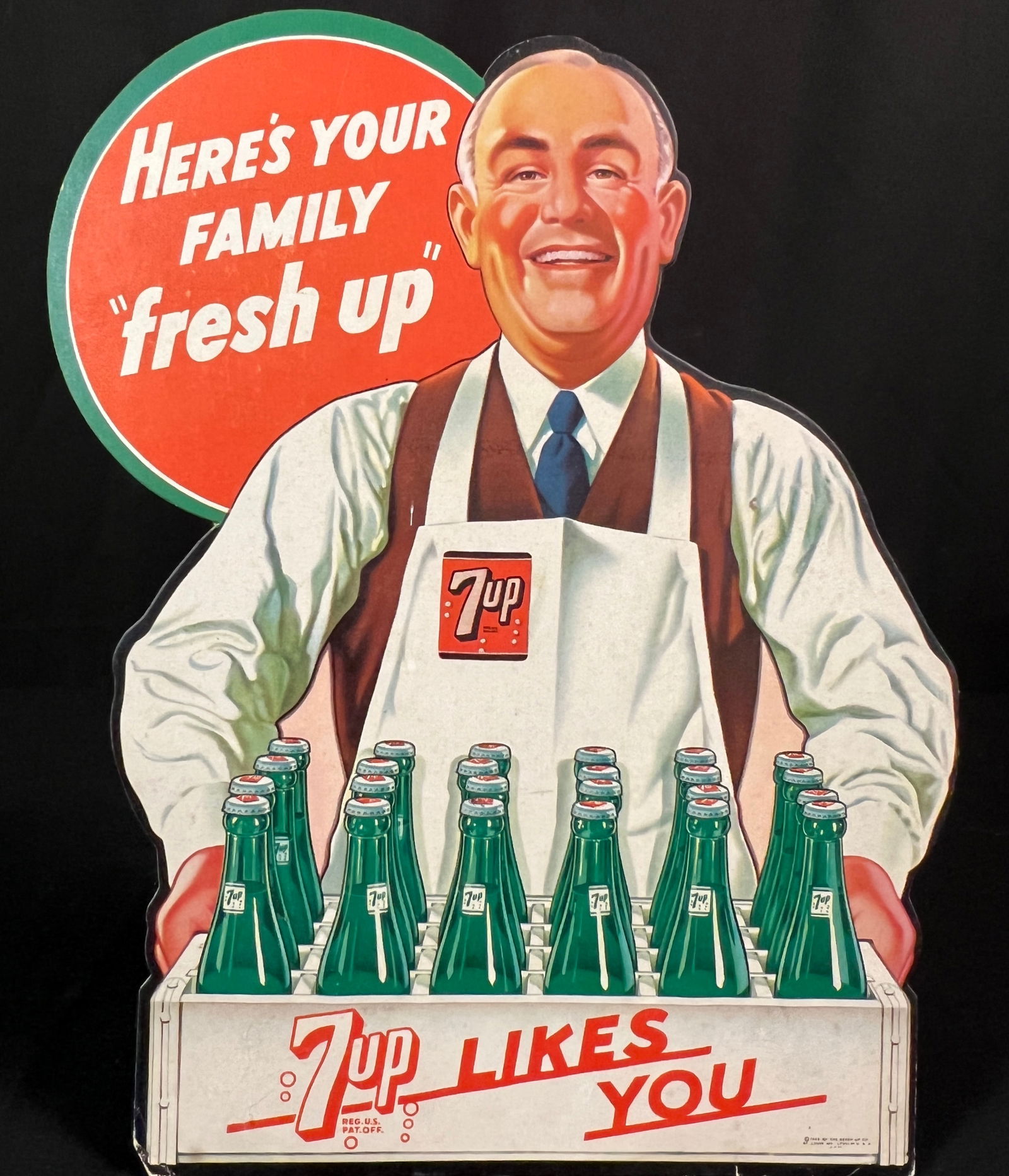 7up Soda Store Display, c1948: A 1948 7up store display countertop advertisement, made from cardboard with a built in stand. In good, as found condition, it measures 12" tall X 9.75" across X 4.25" deep when stand is used.