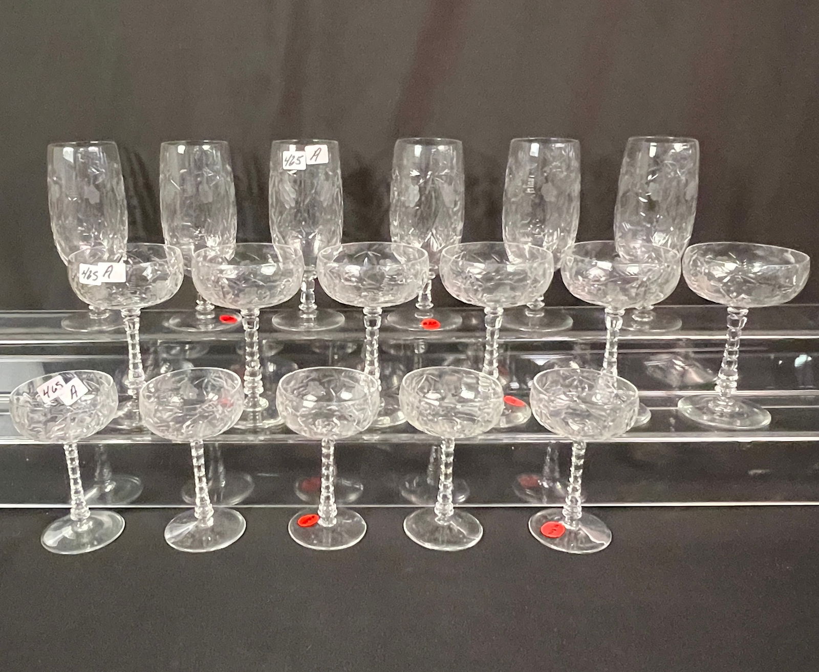 Set of Cut Crystal Stemware: A set of cut crystal Art Deco glasses and goblets to inlcude 6 water, 6 champagne, and 5 cordials. One glass with a flea bite on the rim and one has a sizable chip in the base.