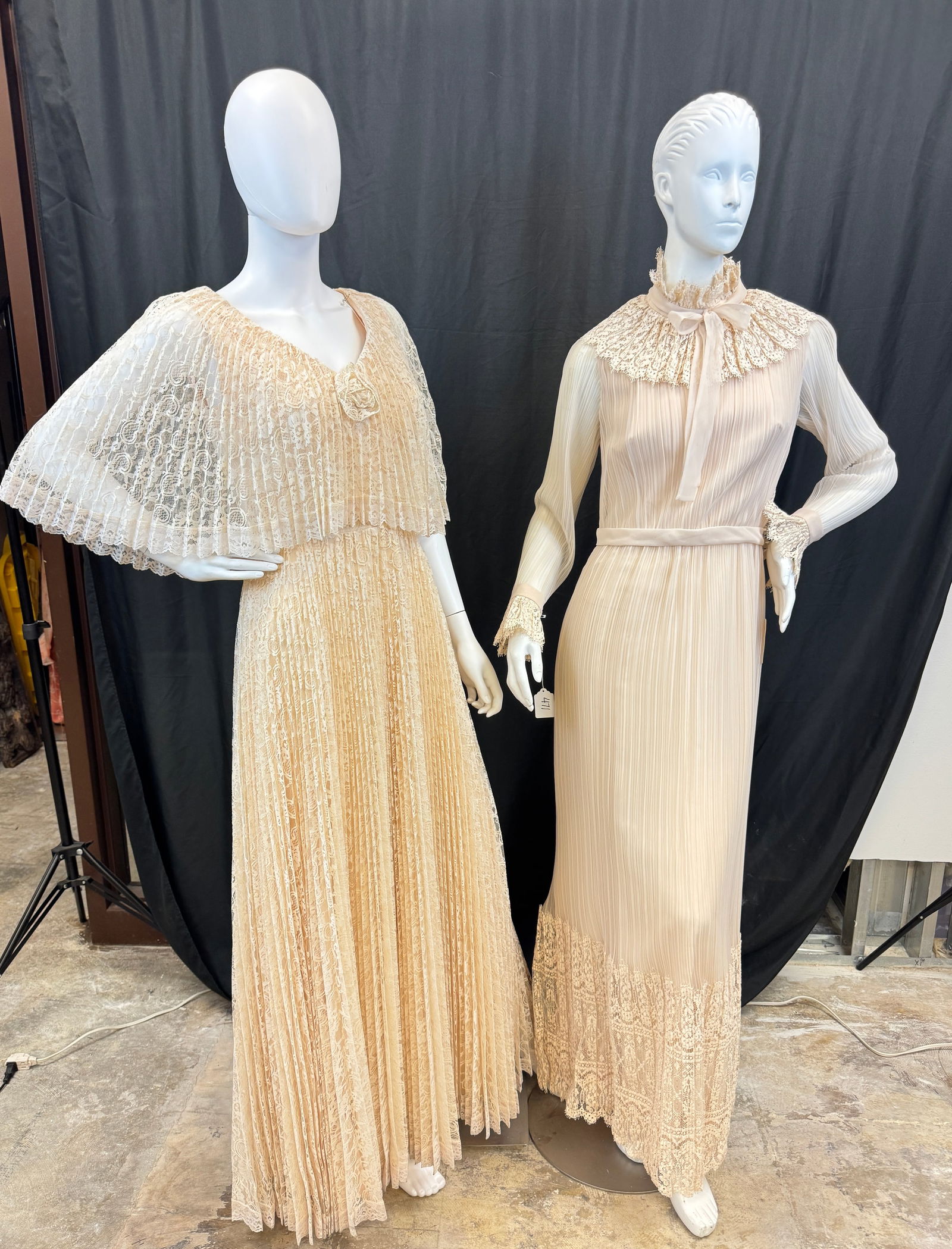2 1970's Maxi Length Lace Gowns: 2 maxi length evening gowns c1970's to include a dead stock Miss Elliette of California pleated sheer champagne colored long sleeve maxi dress with fit and flair silhouette, sheer pleated sleeves, ruf