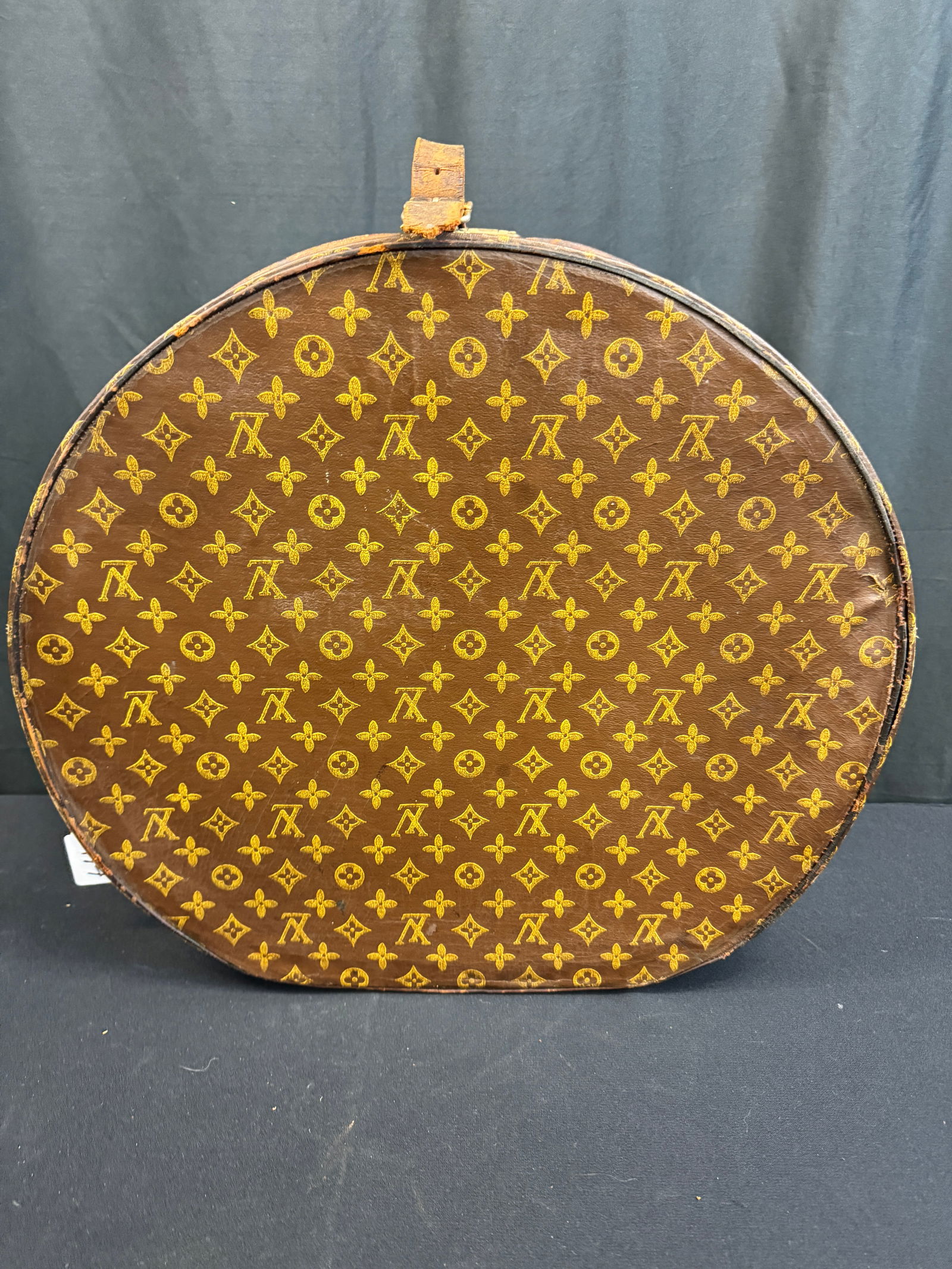 Louis Vuitton Leather Logo Hat Suitcase C1920/30's: A Louis Vuitton leather logo print hat suitcase that features brass signature hardware, wool lining Stenciled EVF initials as well as Milwaukee under the leather closure strap in as found condition.