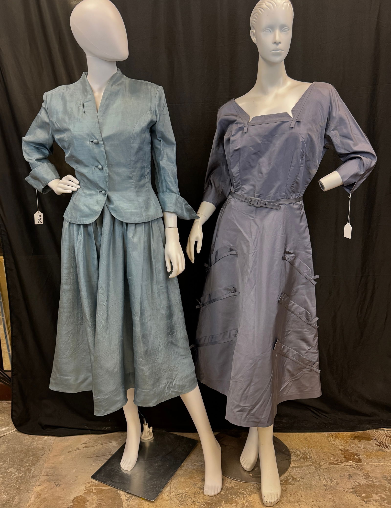 Vintage Group of Silk 1950's Dresses: Two vintage silk 1950's dresses to include a steel blue fit and flare dress with a matching 3 button jacket by OLGA in excellent condition, and a periwinkle silk fit and flare dress with dart tags,