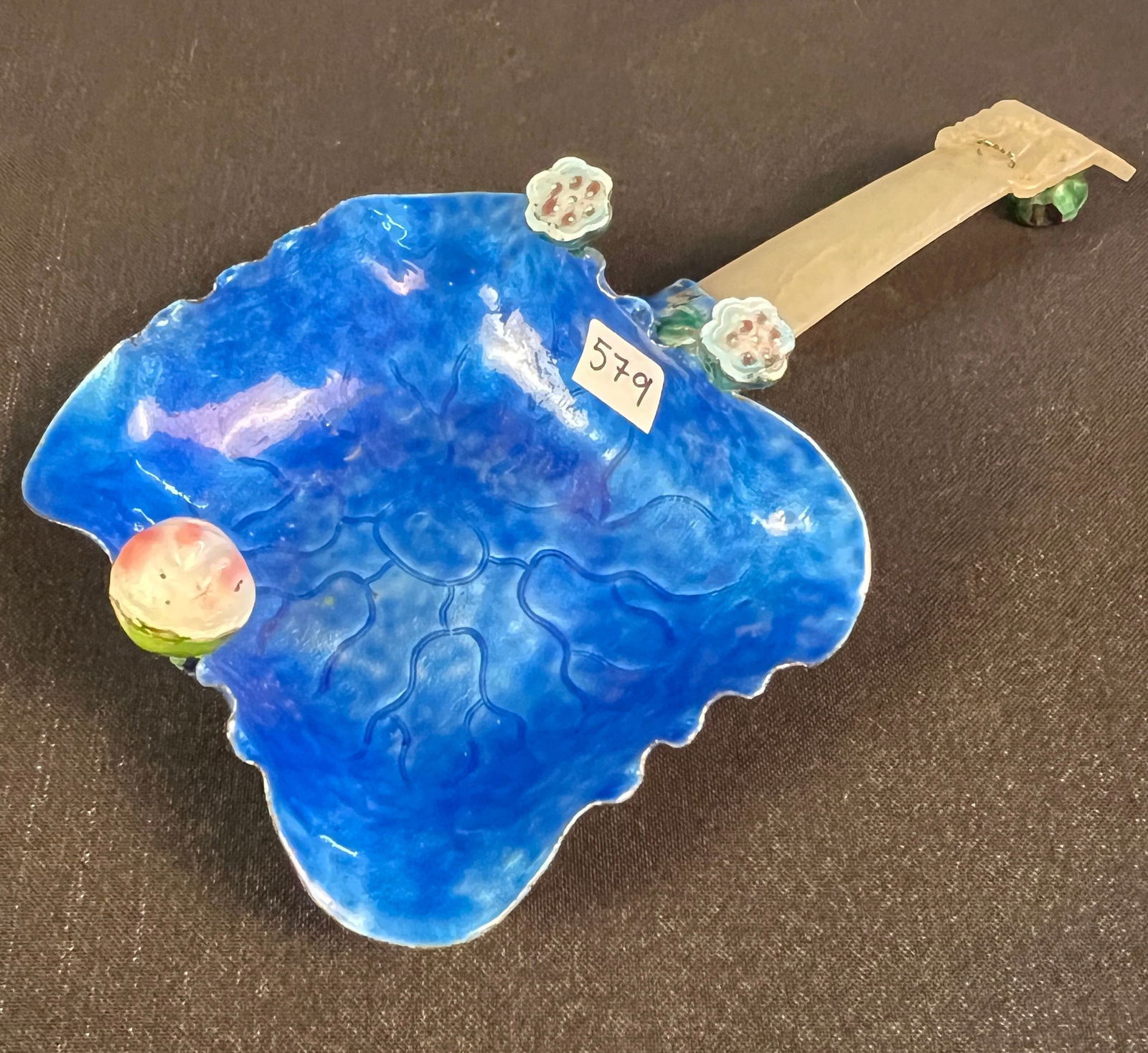 Chinese Copper, Enamel and Jade Bowl: An antique Chinese copper and enamel bowl with a hand-carved jade handle. Dates to the late Qing Dynasty. Crafted from copper and finished with a vibrant blue enamel shaped like a lotus leaf or lily p