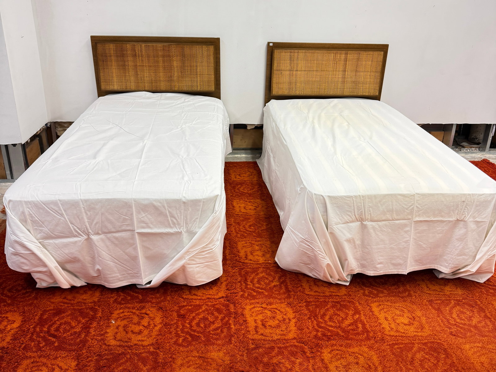 Pair of Paul McCobb Cane and Brass Twin Beds for Calvin Furniture: A pair of Paul McCobb cane and brass twin bed headboards with attatchable metal frames, box springs and mattresses. Headboards are in excellent condition.
