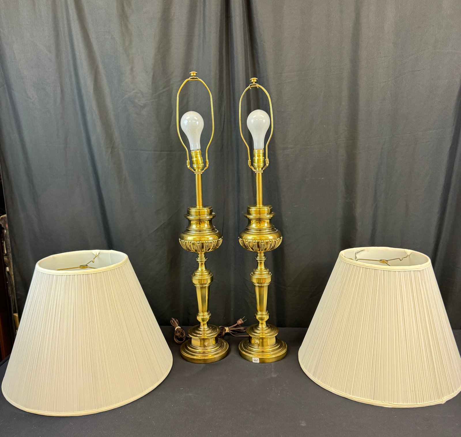 Vintage Stiffle Brass Lamps C1960's: A pir of matching Stiffel brass lamps in excellent conditon thaty feature switches on the base. They each measures 36" tall X 6" across.
