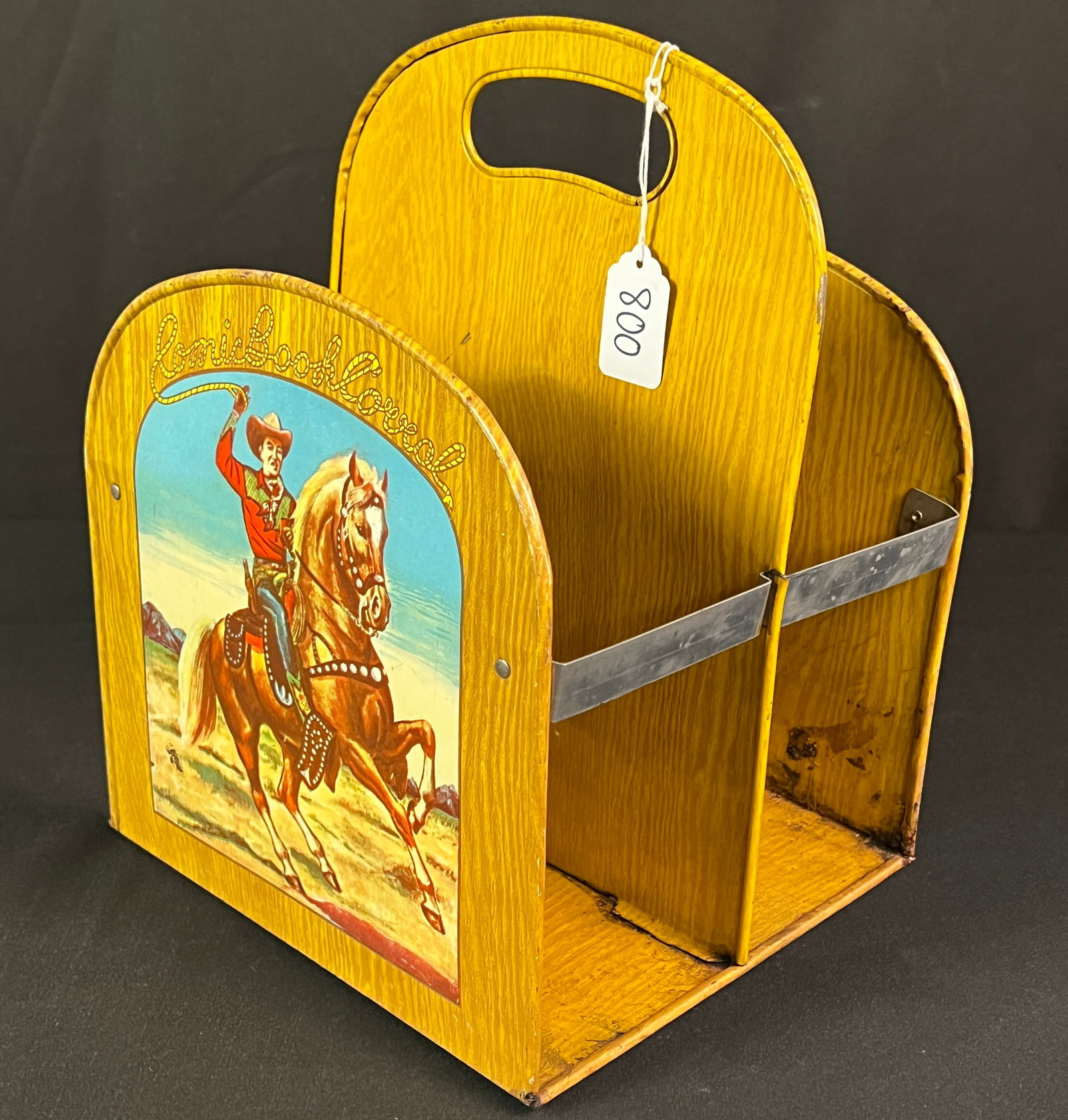 Roy Rogers Comic Book Holder: A Roy Rogers comic book holder, or a "Comic Book Corral". Features Roy Rogers on his horse, Trigger, with a lasso. A popular piece of memorabilia for fans of the "King of the Cowboys". In fair