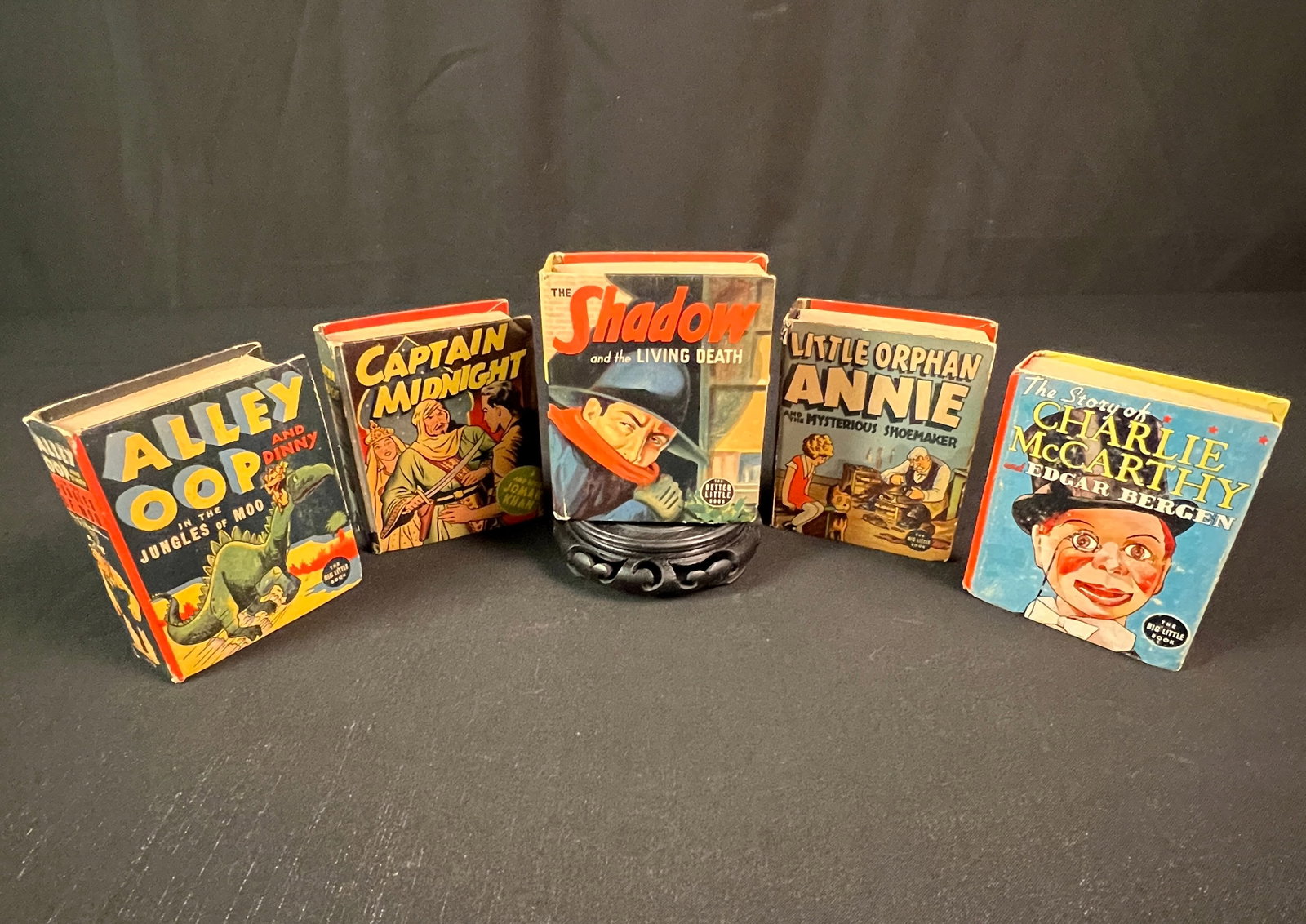 Group of 5 Better Little Book Books: 5 vintage hardcover editions of 'Better Little Book' books to include "Captain Midnight and Sheik Jomak Khan" catalog #1402 and based on the famous newspaper strip, a 1938 first edition of "The Story