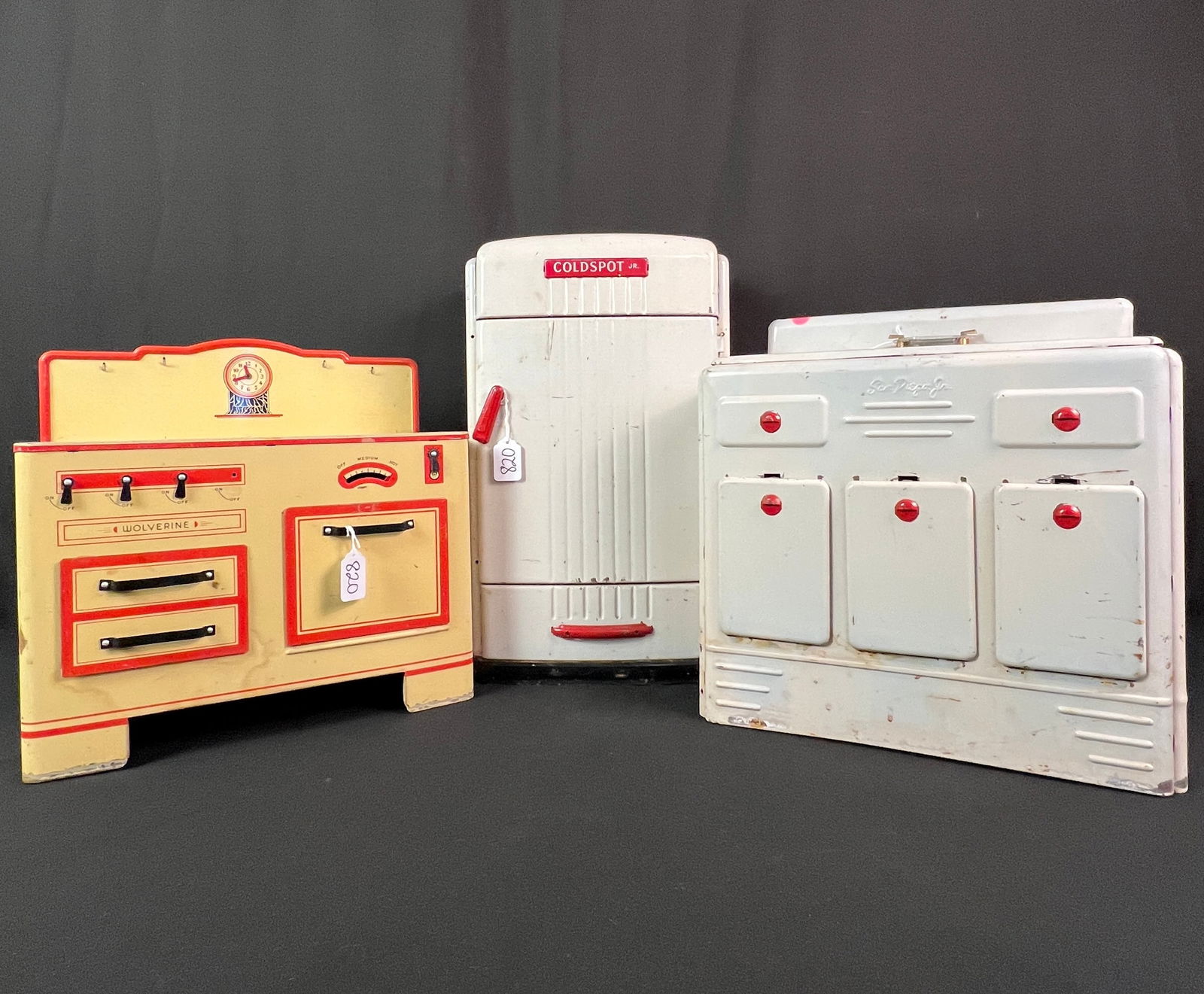 Tin Litho Toy Kitchen Appliances: A group of vintage toy kitchen appliances to include a Coldspot Jr. metal toy refigerator, c.1940s/50s that features an opening door, interior racks, a freezer drawer and ice cube drawers (18.5" tall