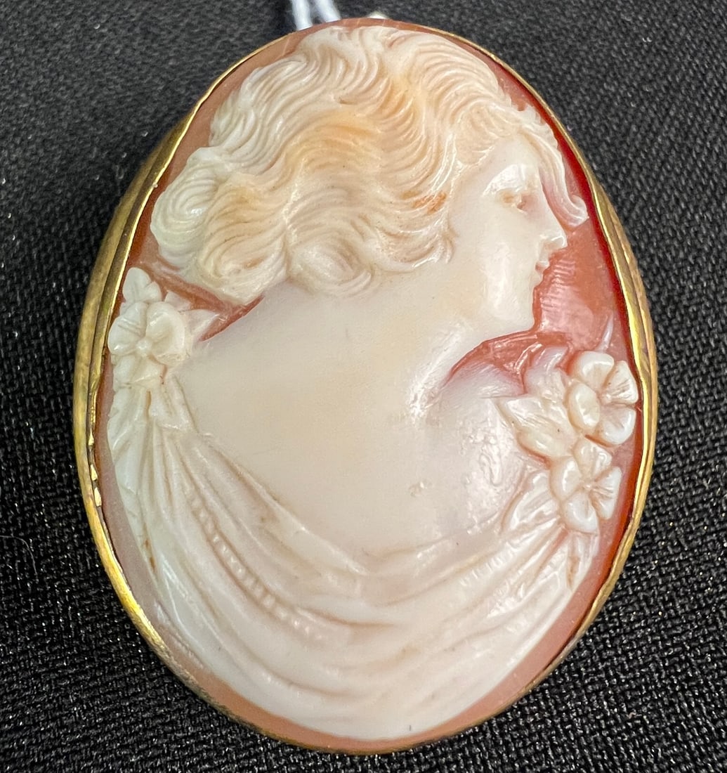 12K Gold Filled Cameo c. 1900: A 12K gold filled cameo of a woman from the turn of the century. Very well carved, it measures 1.75" tall.