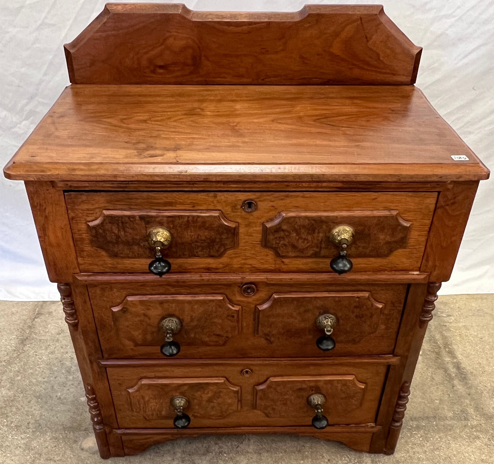 Walnut Commode: A walnut commode by A.P. Johnson and Co, featuring large tear drop pulls. In fair condition, it measures ...