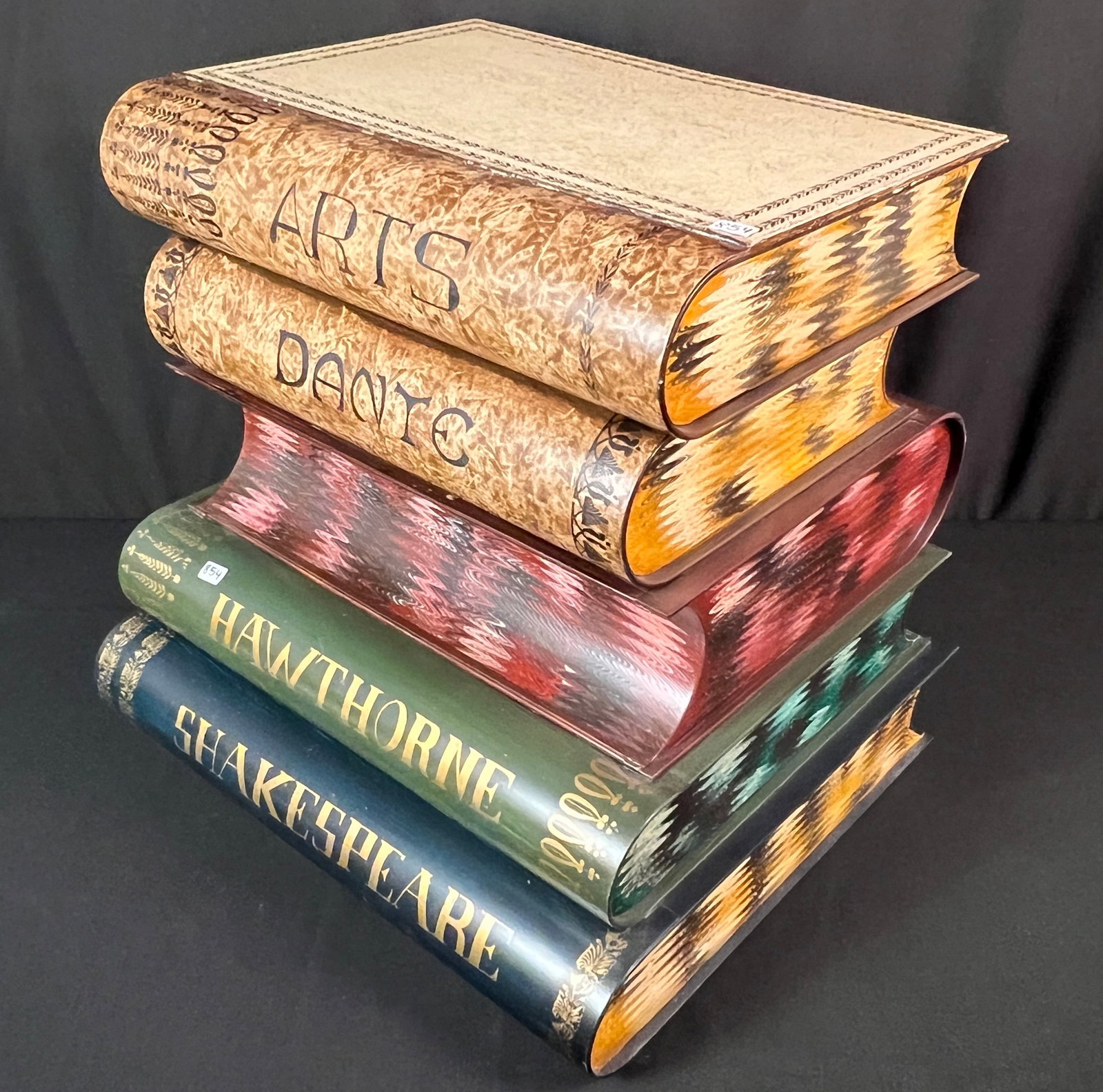 1950s Italian Storage Box: A vintage 1950s Italian hand-painted tolewear metal flip top storage box in the form of stacked books. The books are titled "Arts", "Dante", "Goethe", "Hawthorne", and "Shakespeare". In great