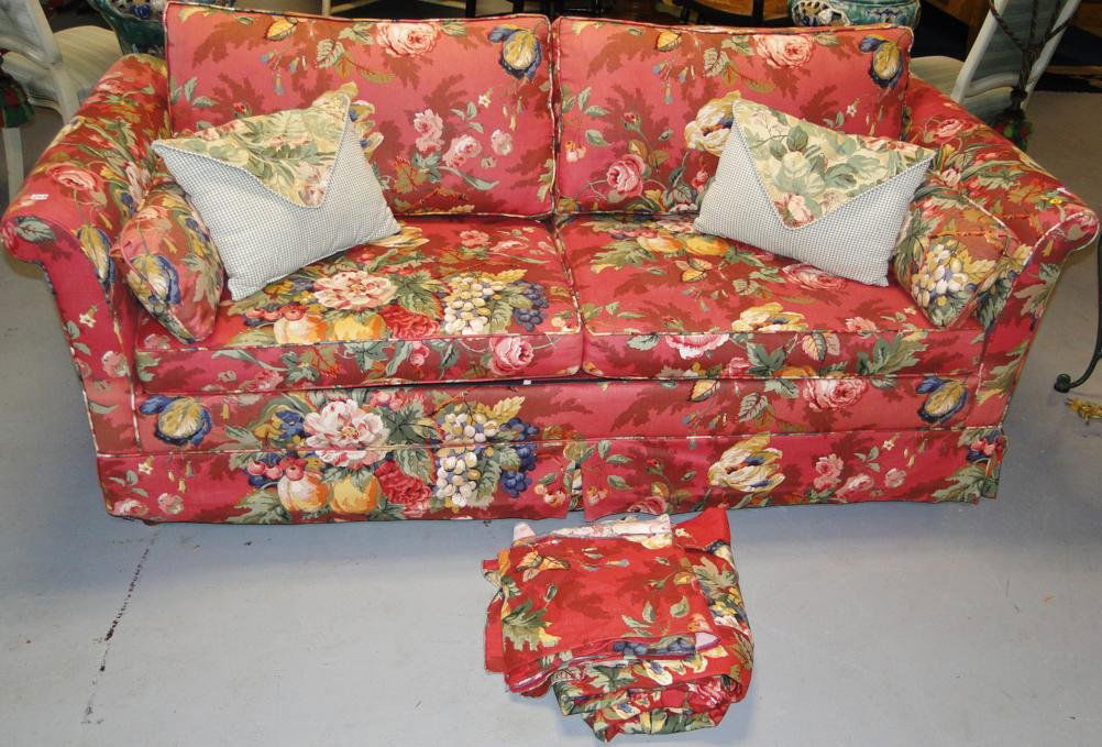 Floral print sleeper sofa with loads of accent pillows,