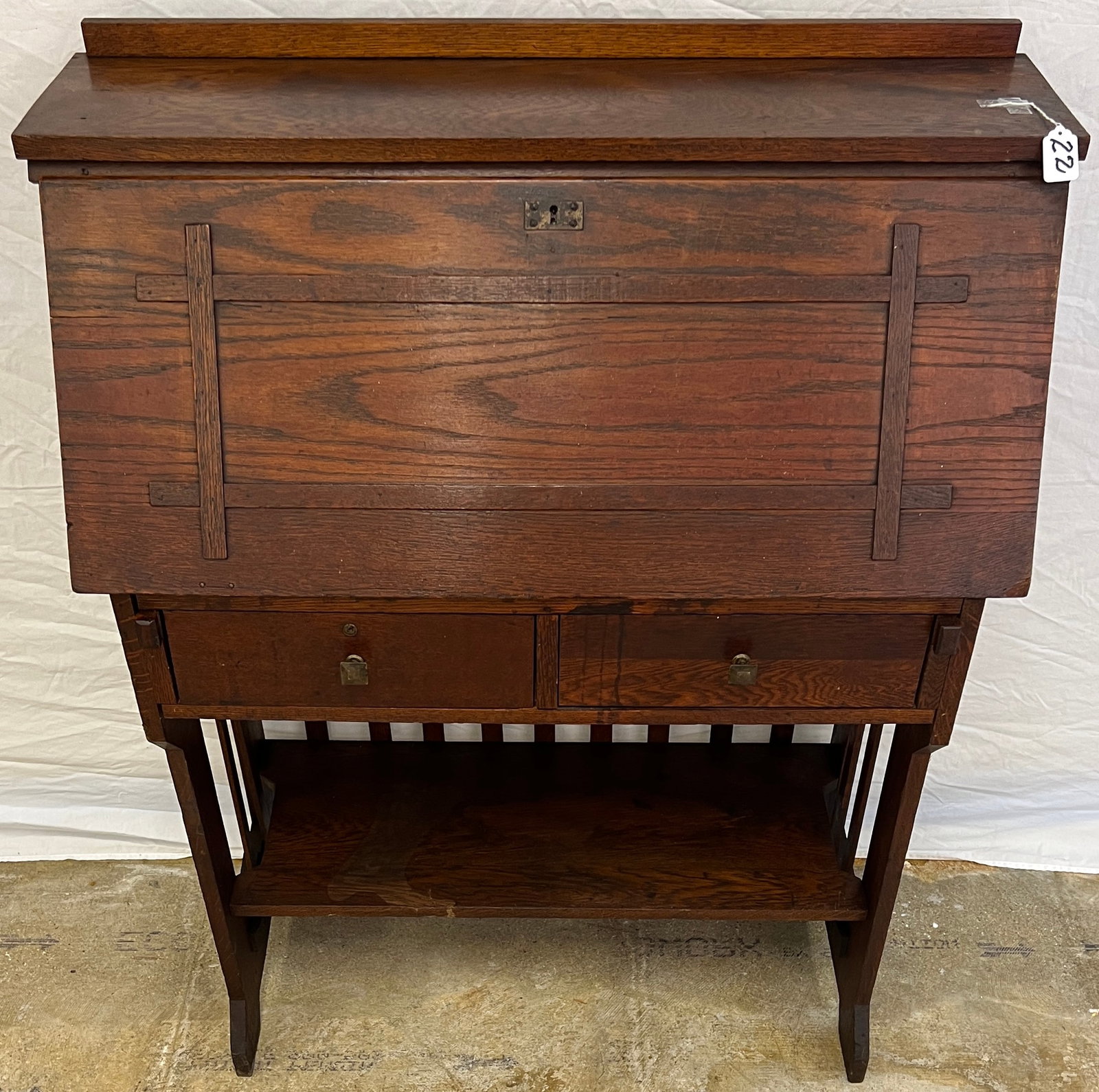 Mission Oak Drop Front Desk: A Mission oak drop front desk with double drawers, slatted sides and fitted interior. Piece is in original finish and measures 45" tall X 34" across X 15" deep.