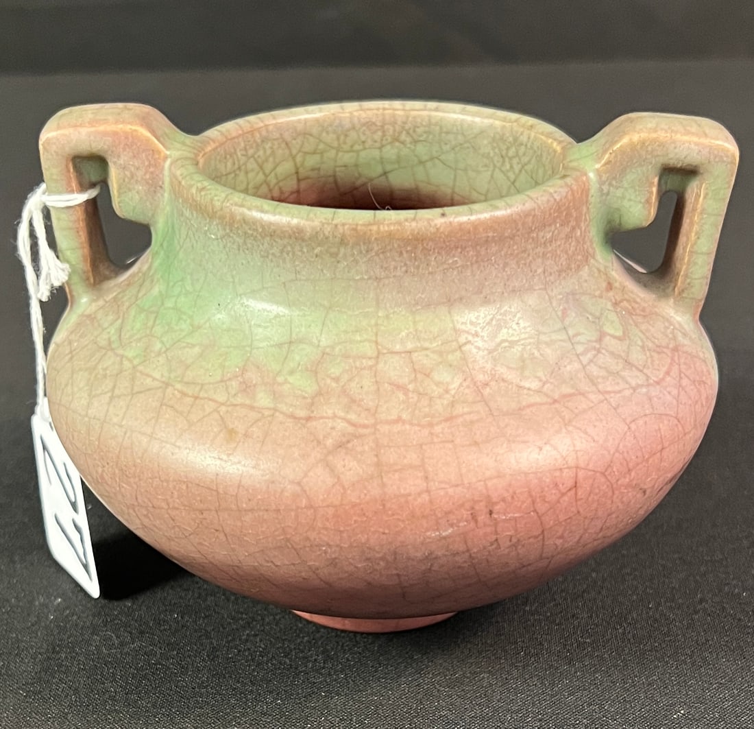 Rookwood Double Handled Grecian Style Vase c. 1916: A lovely Rookwood Pottery double handled Grecian Style vase. It features mauve to green coloration with a crackle finish, bottom is dated 1916. Excellent condition, it measures 4" tall X 5.5" across.