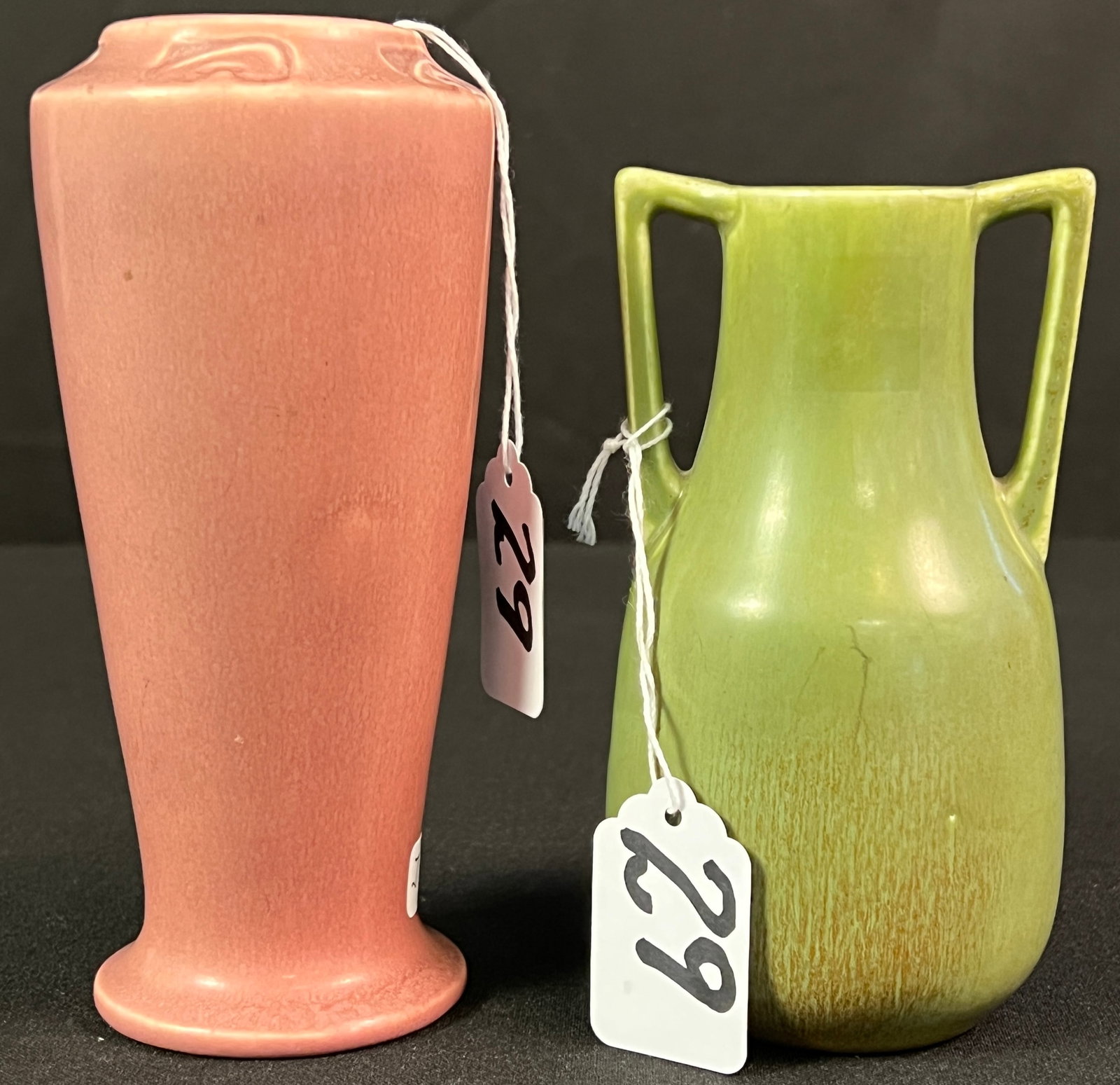2 Pieces of Rookwood Pottery: 2 pieces of Rookwood Pottery to include an olive green double handled vase dating to 1922 (measures 5.5" tall X 3" across) and a mauve vase dated 1921 (measures 6.25" tall). Both are in excellent cond