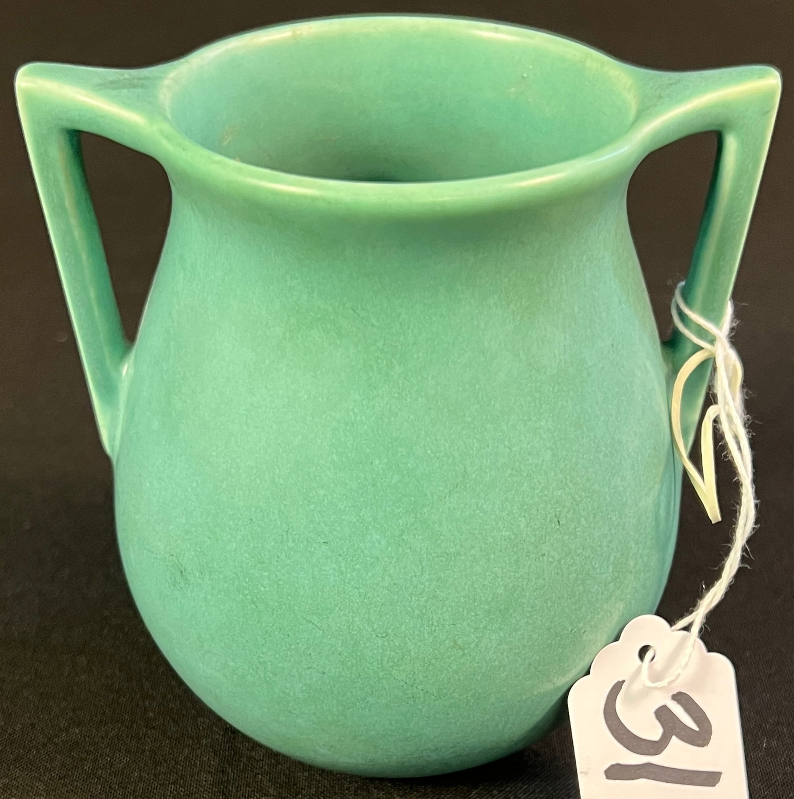 Rookwood Pottery Double Handled Vase: A Rookwood Pottery double handled vase in turquoise finish, it dates to 1938 and measures 4.25" tall X 4.25" across.