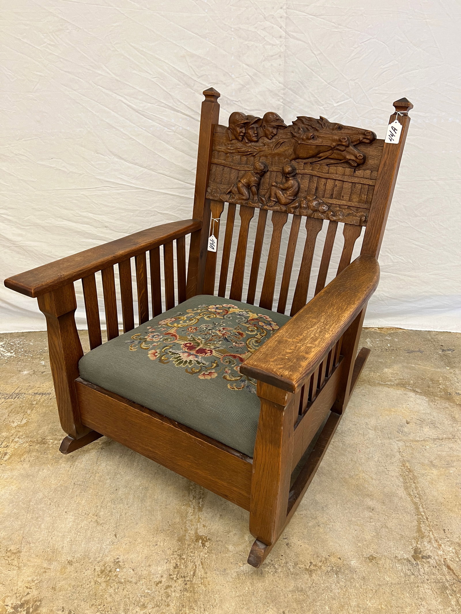 Mission Oak Rocker W/Hand Carved Jockey & Horses: A Mission Oak rocker c.1900's with elaborately hand carved jockeys and horses with young kids watching the race. This extremely detailed pub rocker is a work of art. This wonderful example of wood car