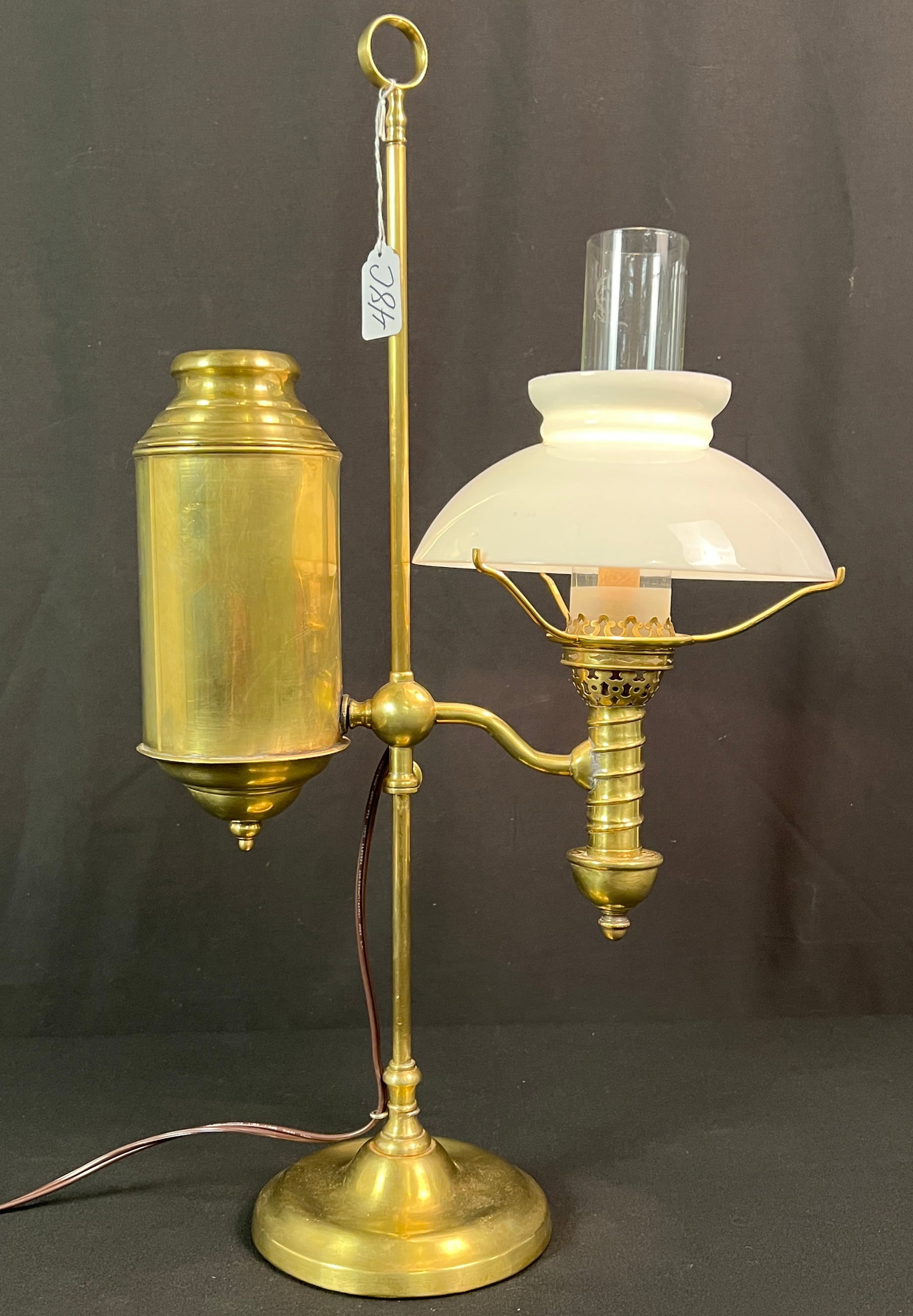 Antique Student Lamp: An antique student lamp that has been professionally polished, original shade and has been electrified. It is still adjustable and can be converted back easily. In excellent condition, it measures 22.