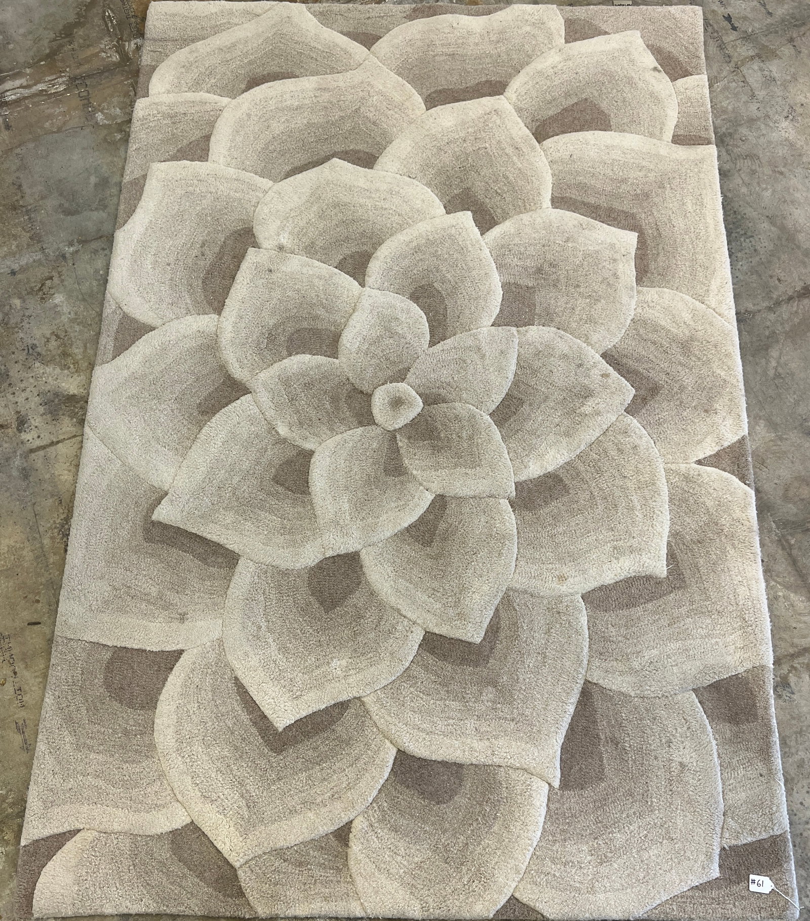 Contemporary Designer Wool Rug: A contemporary designer rug featuring a large outward expanding flower done in various tones of beige. This rug has a thick pile and measures 108" X 71"