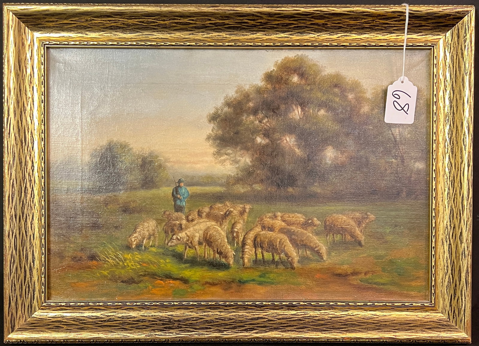 Arts and Crafts Oil on Canvas of Shepherd with Sheep: A circa 1920s oil on canvas depicting a shepherd with a flock of sheep. The painting is unsigned, but is well executed and retains its original period frame. Back frame has a sticker from MUELLER