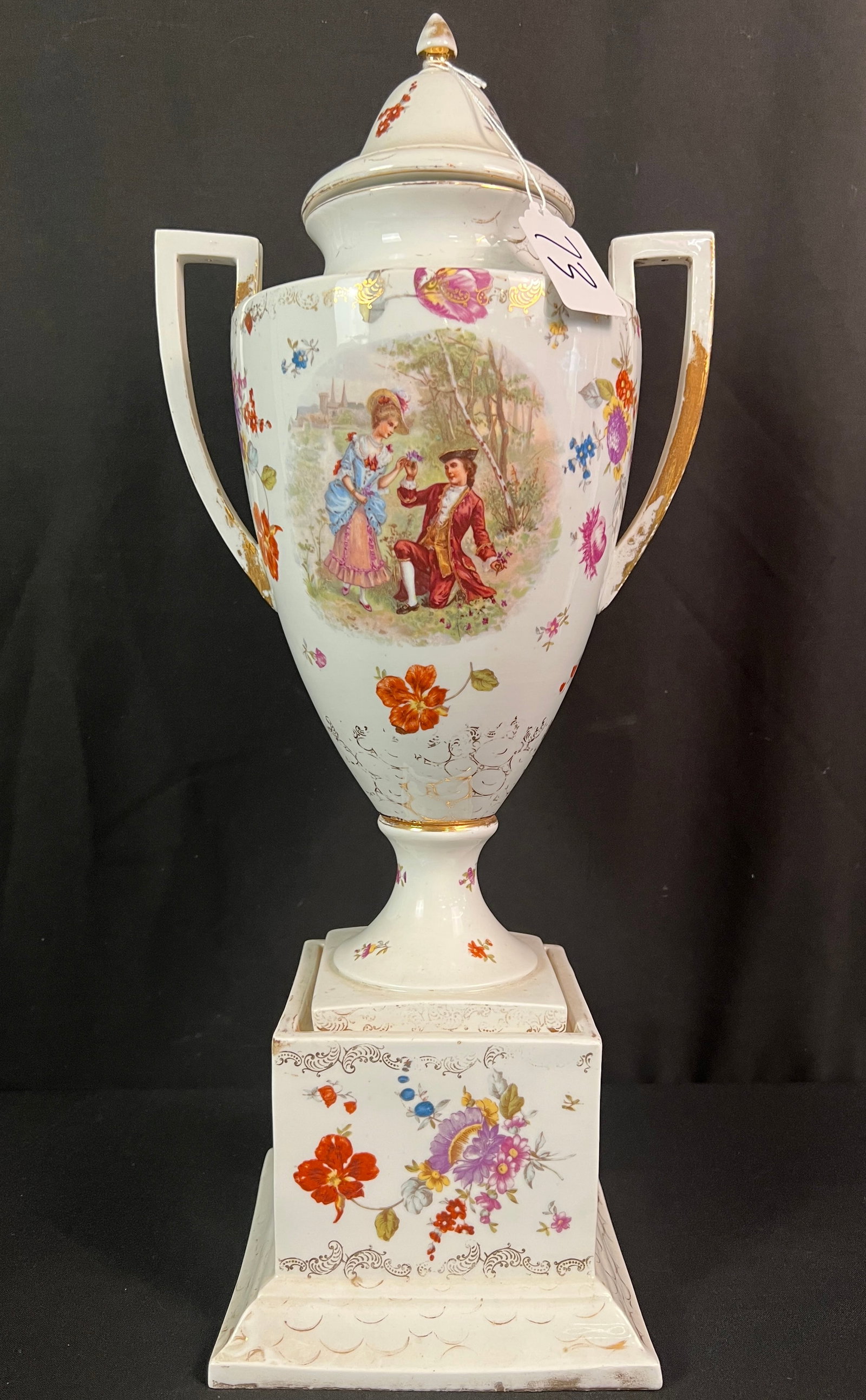 Royal Vienna Porcelain Lidded Urn late 19th Century: A tall porcelain lidded urn c.1880-1900 with the Royal Vienna beehive mark on the bottom. It features courtly scenes and flowers. Body of urn is in excellent condition, wear noted to gilding. It
